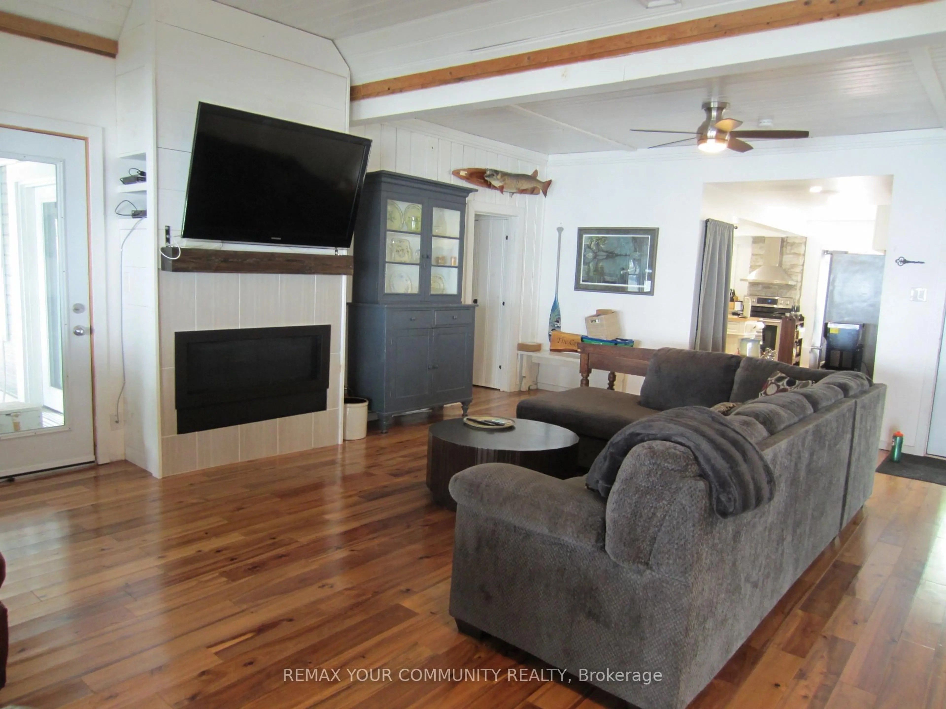 Living room with furniture, wood/laminate floor for 6576 Quarry Point Rd, Ramara Ontario L3V 0S3