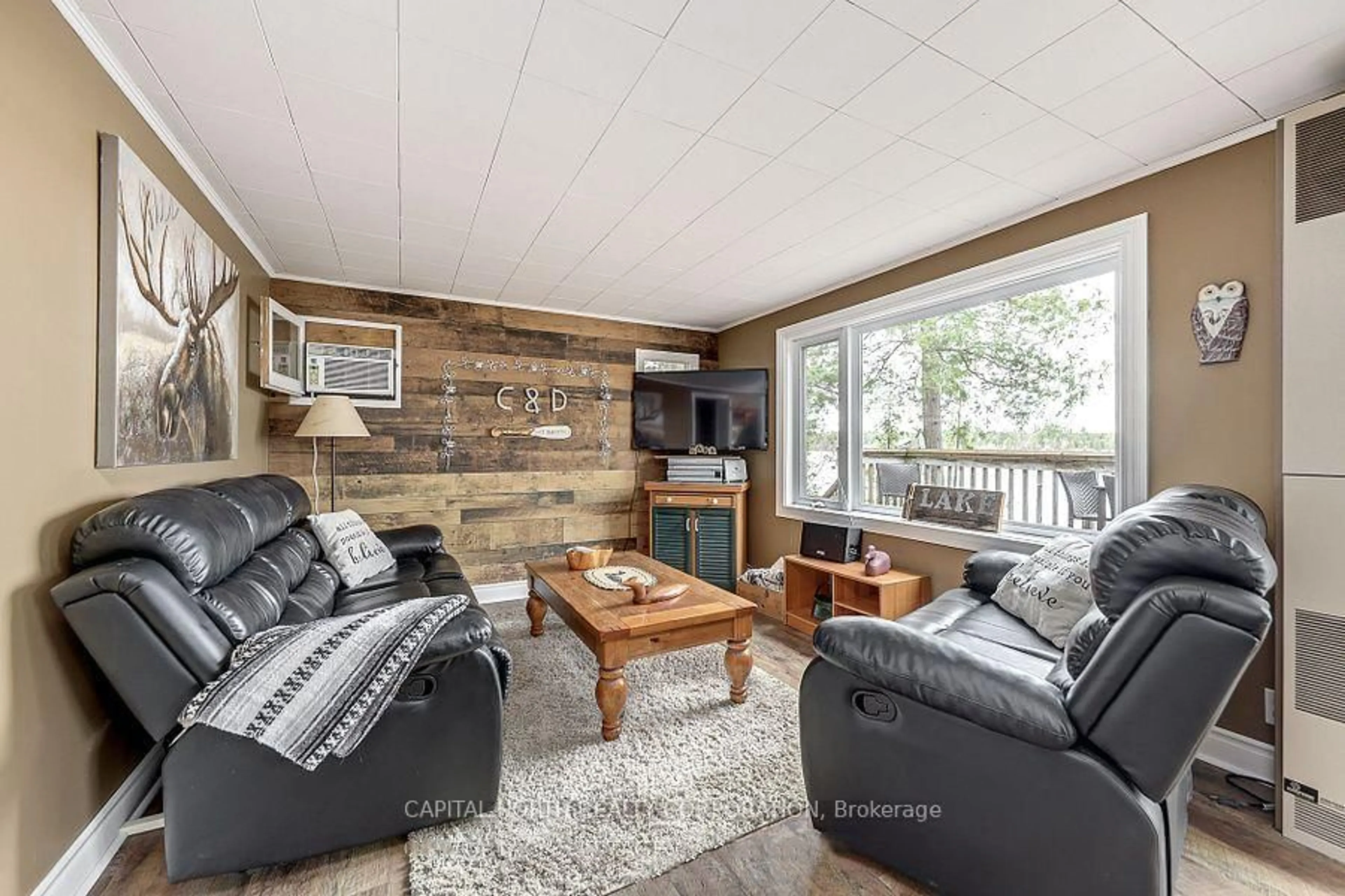 Living room with furniture, wood/laminate floor for 1342 Black Beach Lane, Ramara Ontario L0K 1B0
