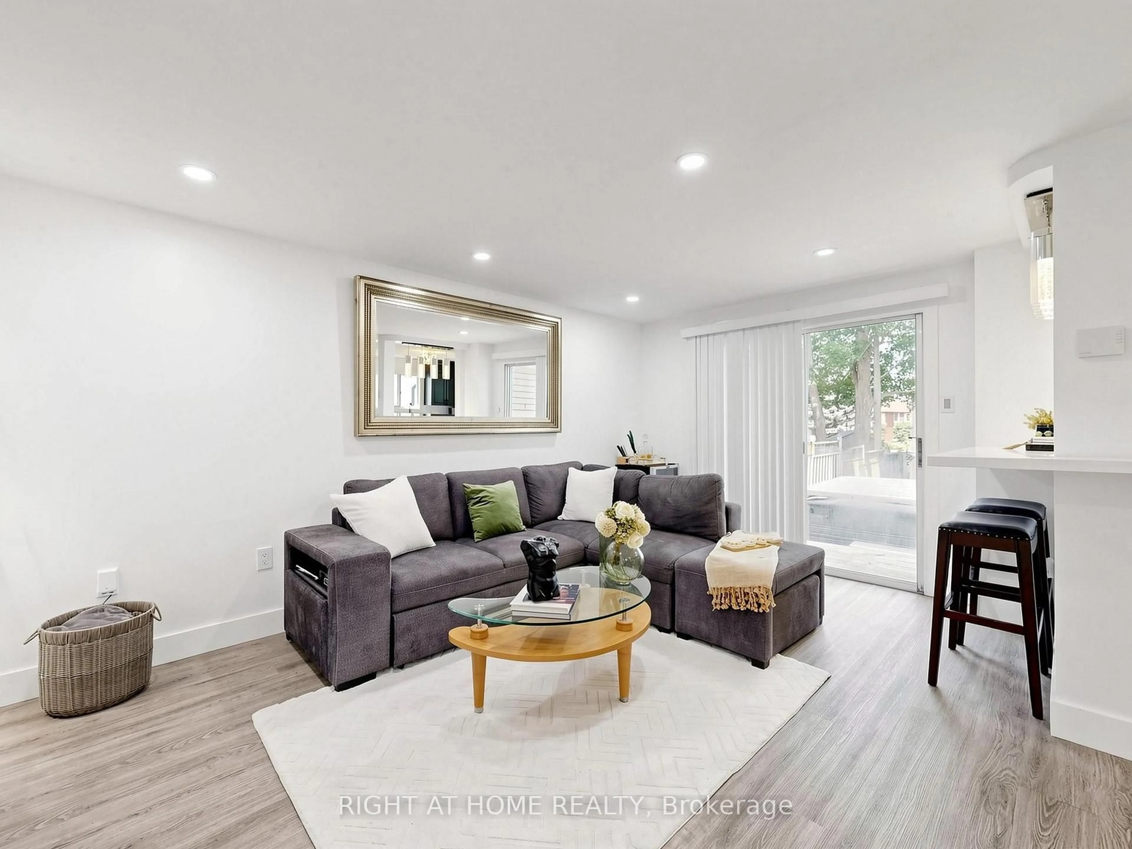 Living room with furniture, wood/laminate floor for 207 Hickling Tr, Barrie Ontario L4M 5W6