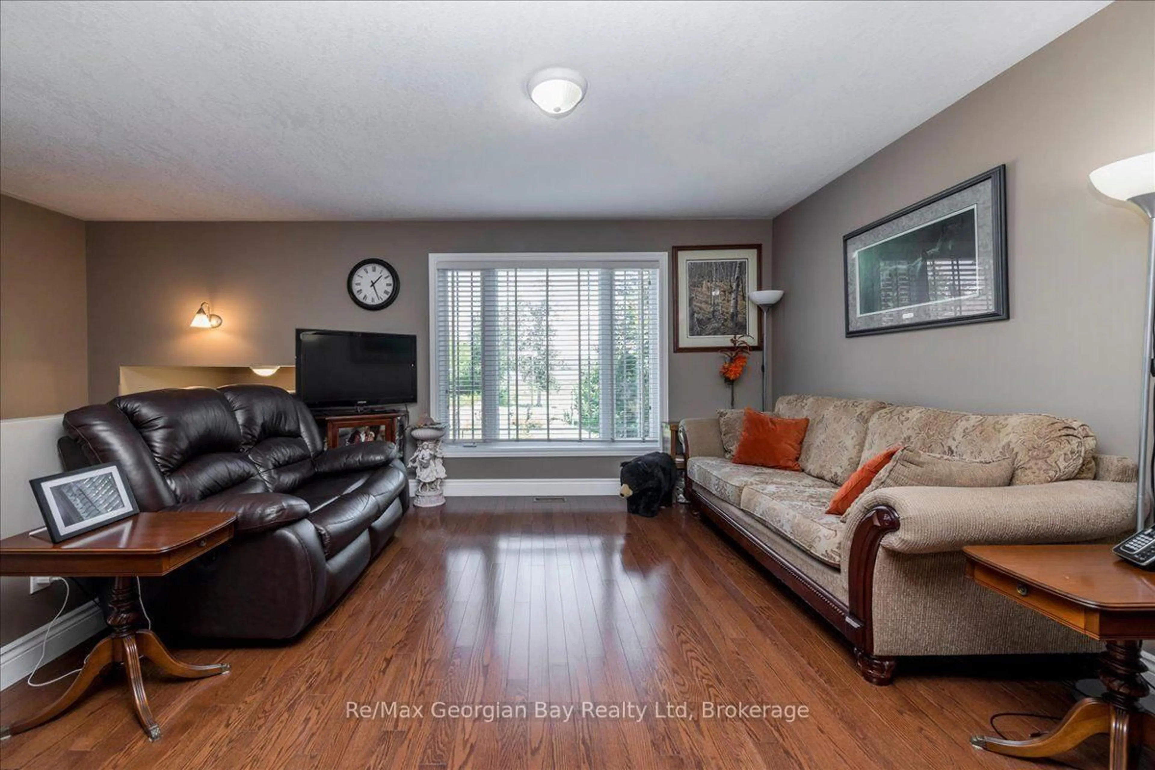 Living room with furniture, wood/laminate floor for 110 Maskinonge Rd, Tay Ontario L0K 2A0