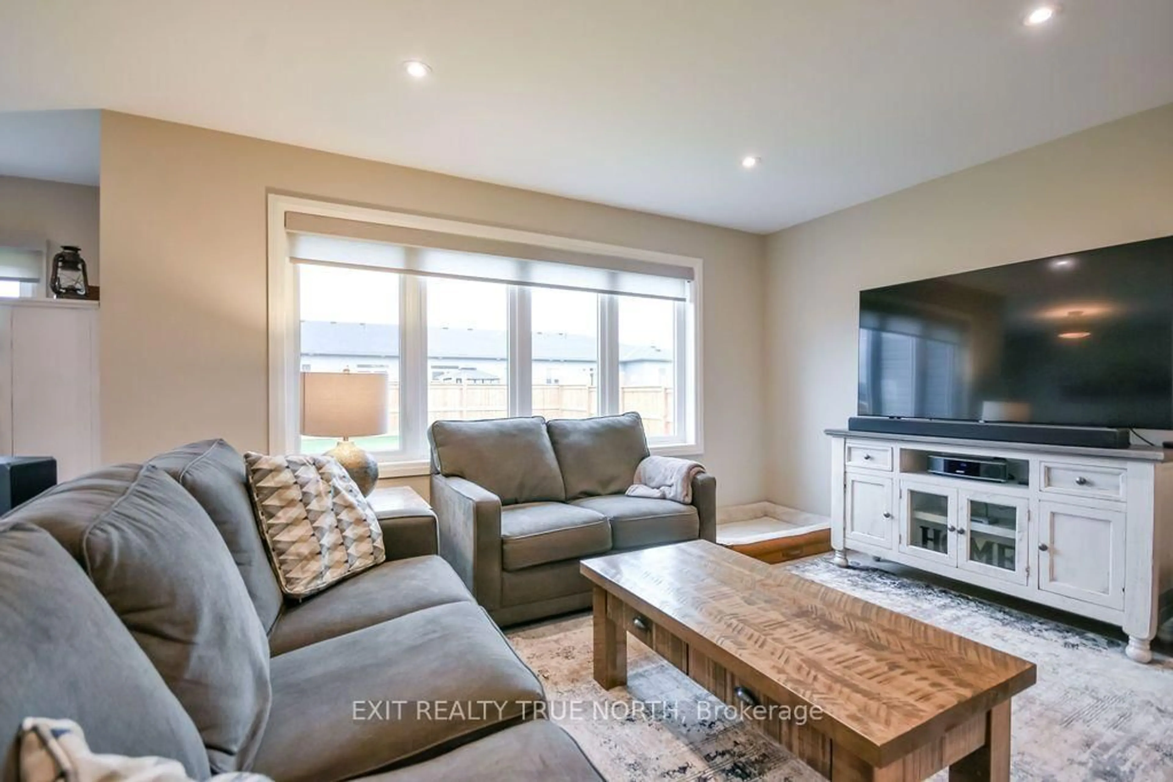 Living room with furniture, wood/laminate floor for 51 Harold Ave, Severn Ontario L0K 1E0