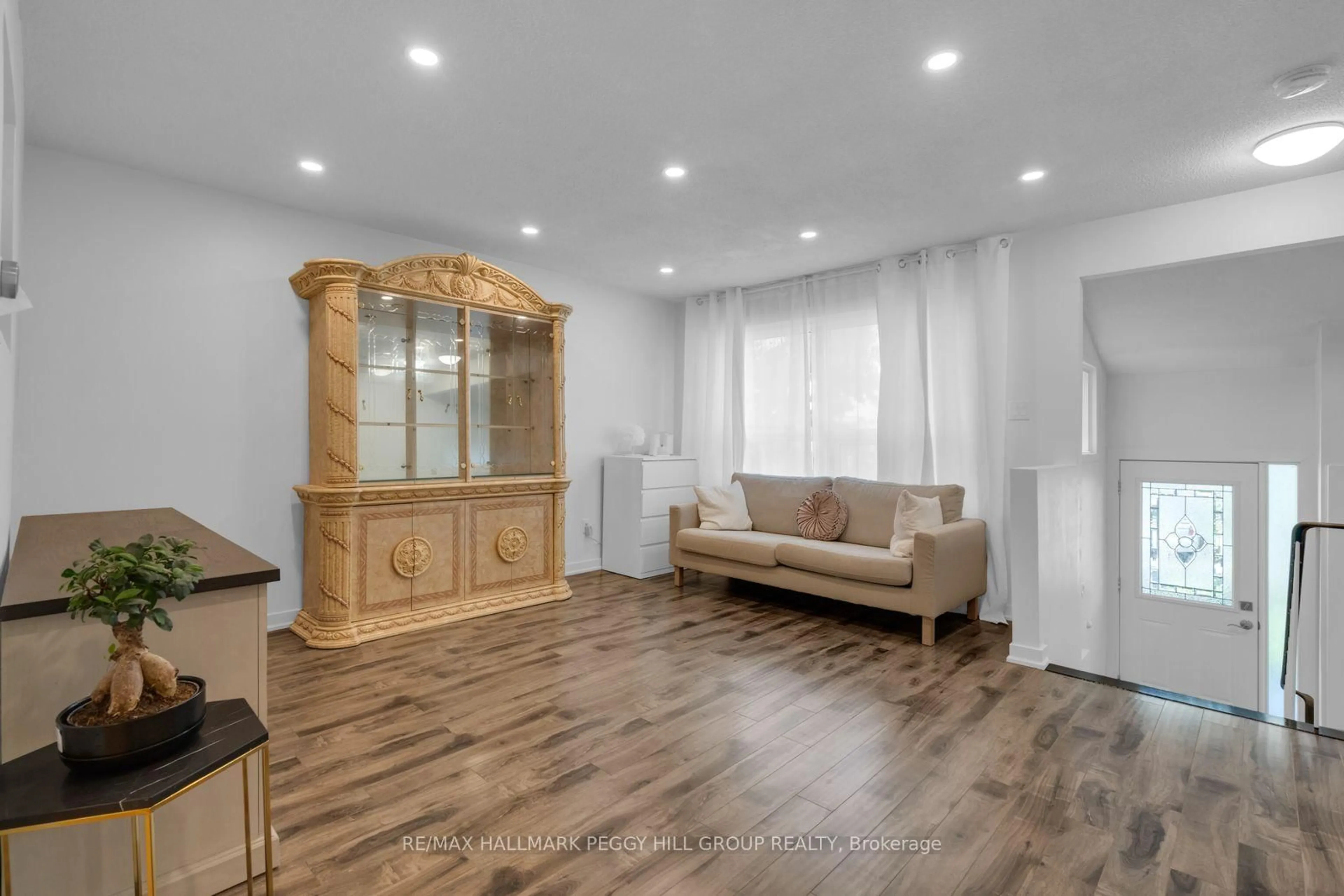 Living room with furniture, wood/laminate floor for 63 Ferris Lane #B1, Barrie Ontario L4M 5C4