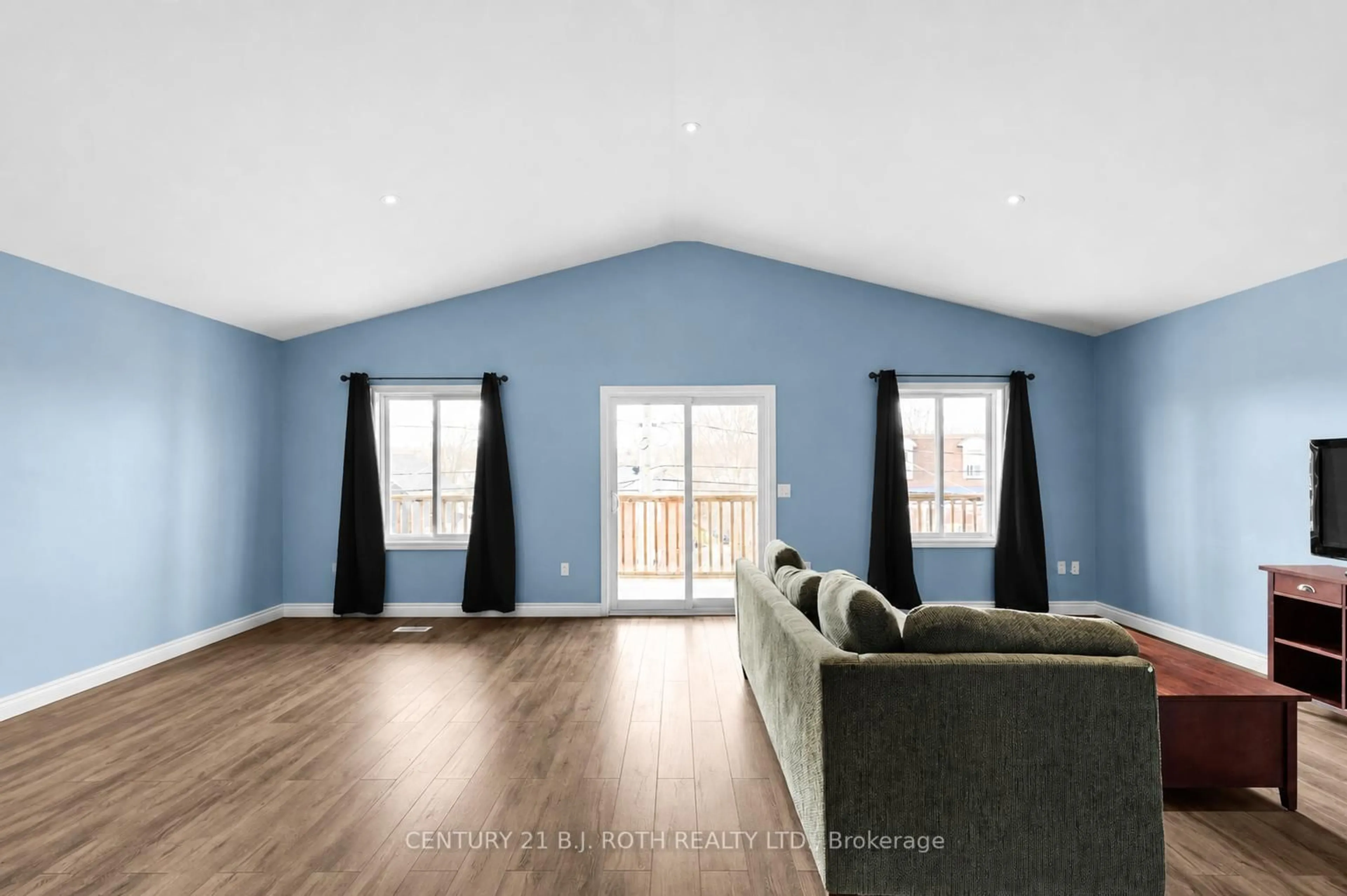 Living room with furniture, wood/laminate floor for 102 Dunlop St, Orillia Ontario L3V 5P4