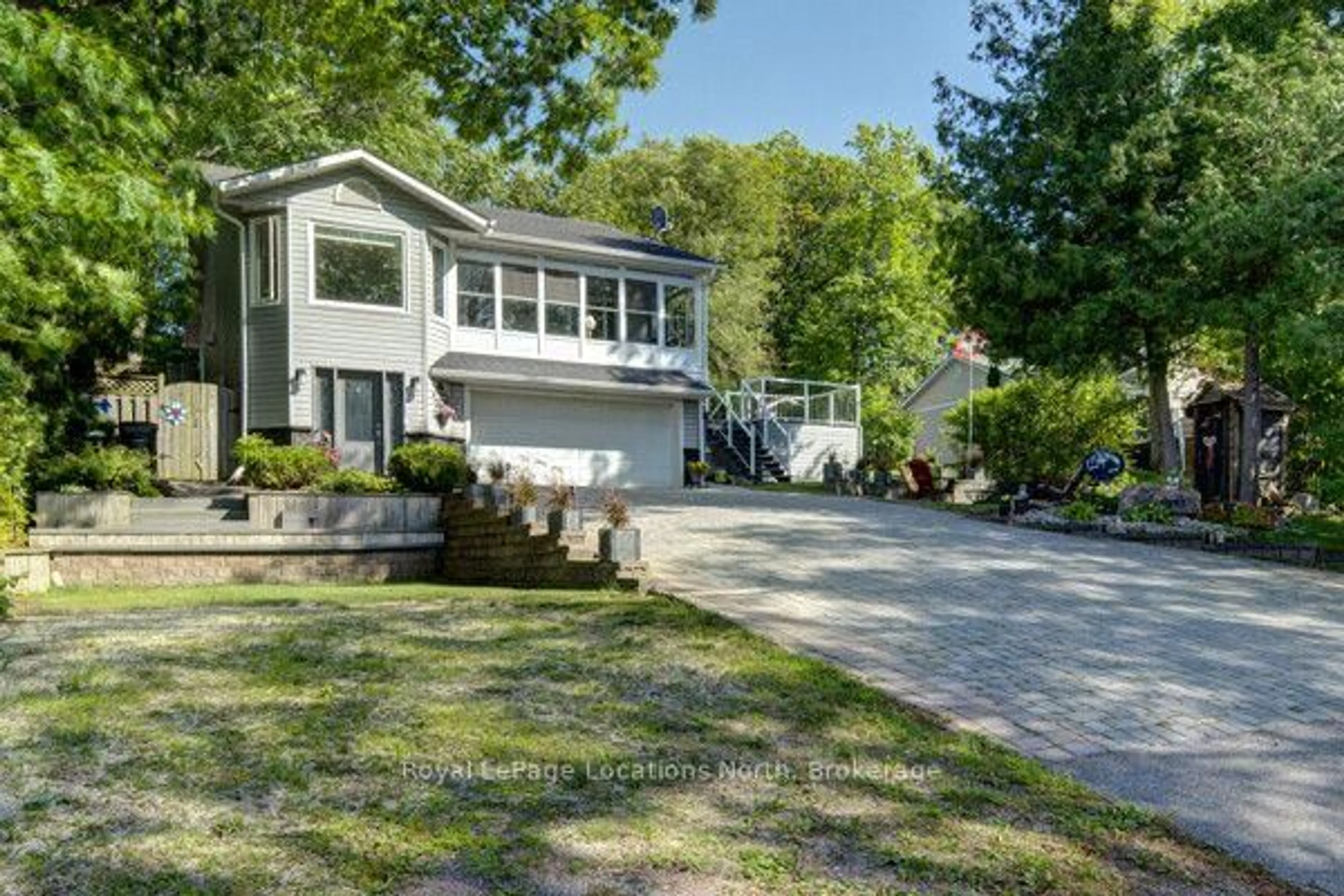 Home with vinyl exterior material, street for 2225 Tiny Beaches Rd, Tiny Ontario L0L 1P1