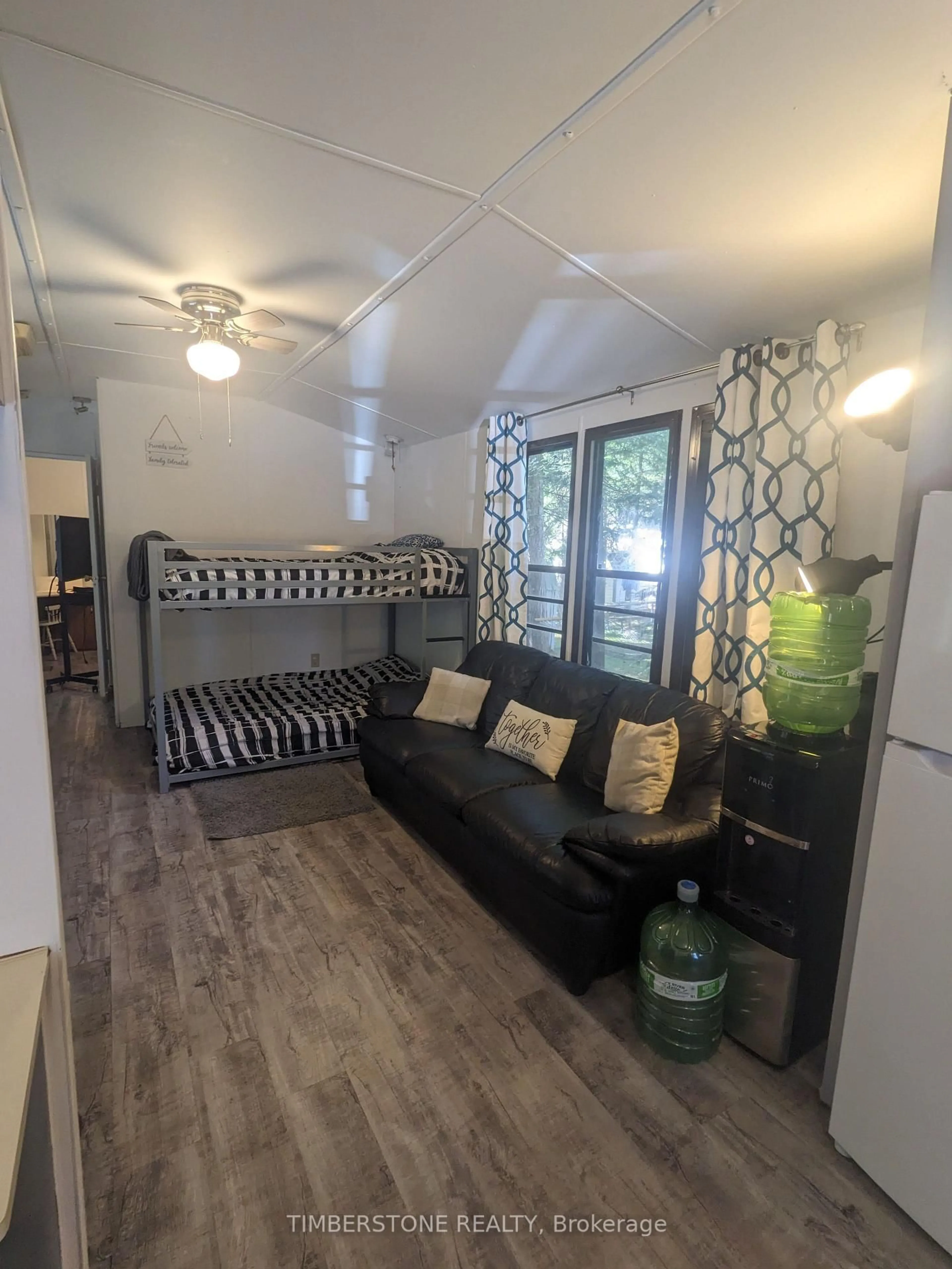 Living room with furniture, wood/laminate floor for 85 Theme Park Dr #258, Wasaga Beach Ontario L9Z 1X7