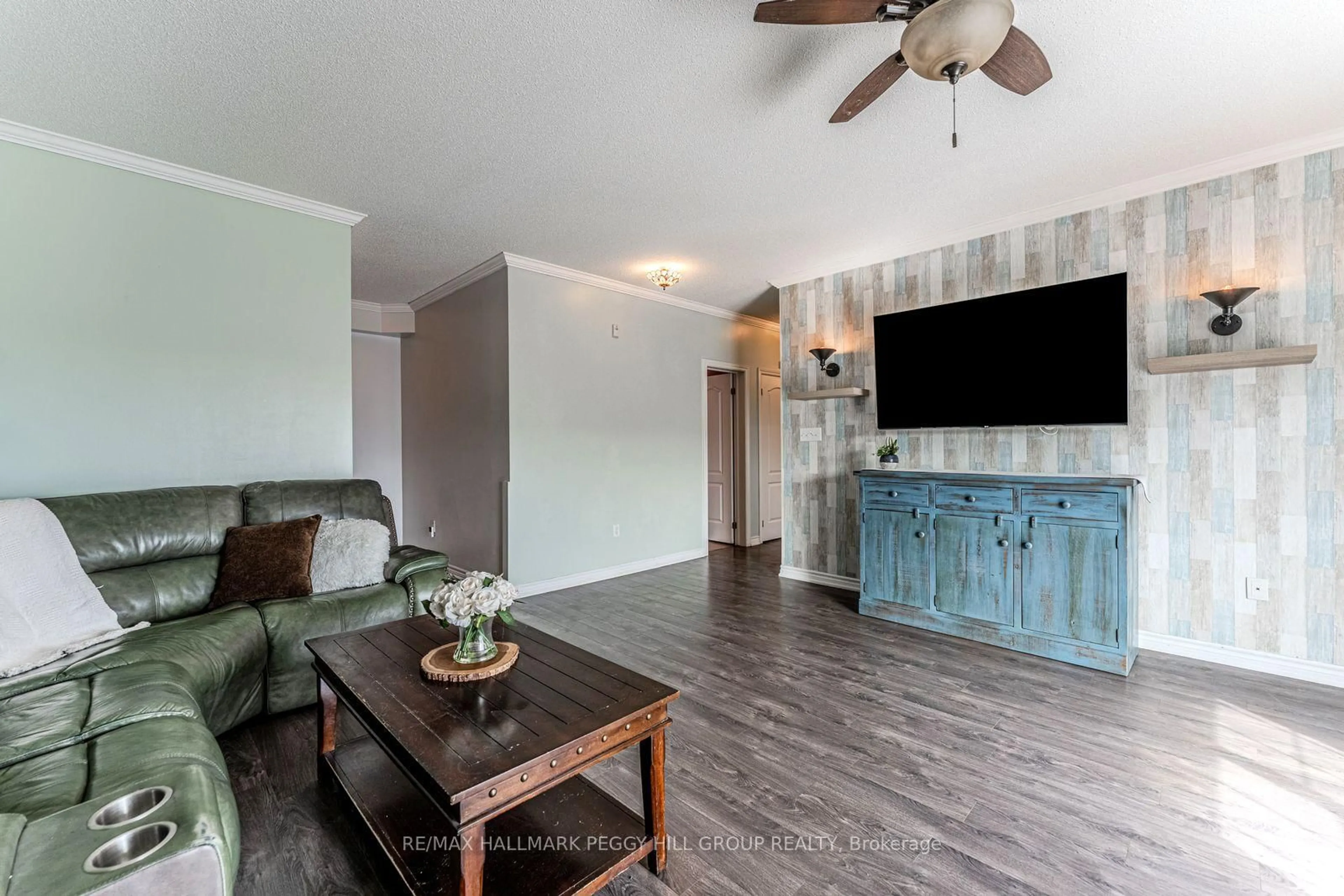 Living room with furniture, wood/laminate floor for 40 Ferndale Dr #402, Barrie Ontario L4N 2L3
