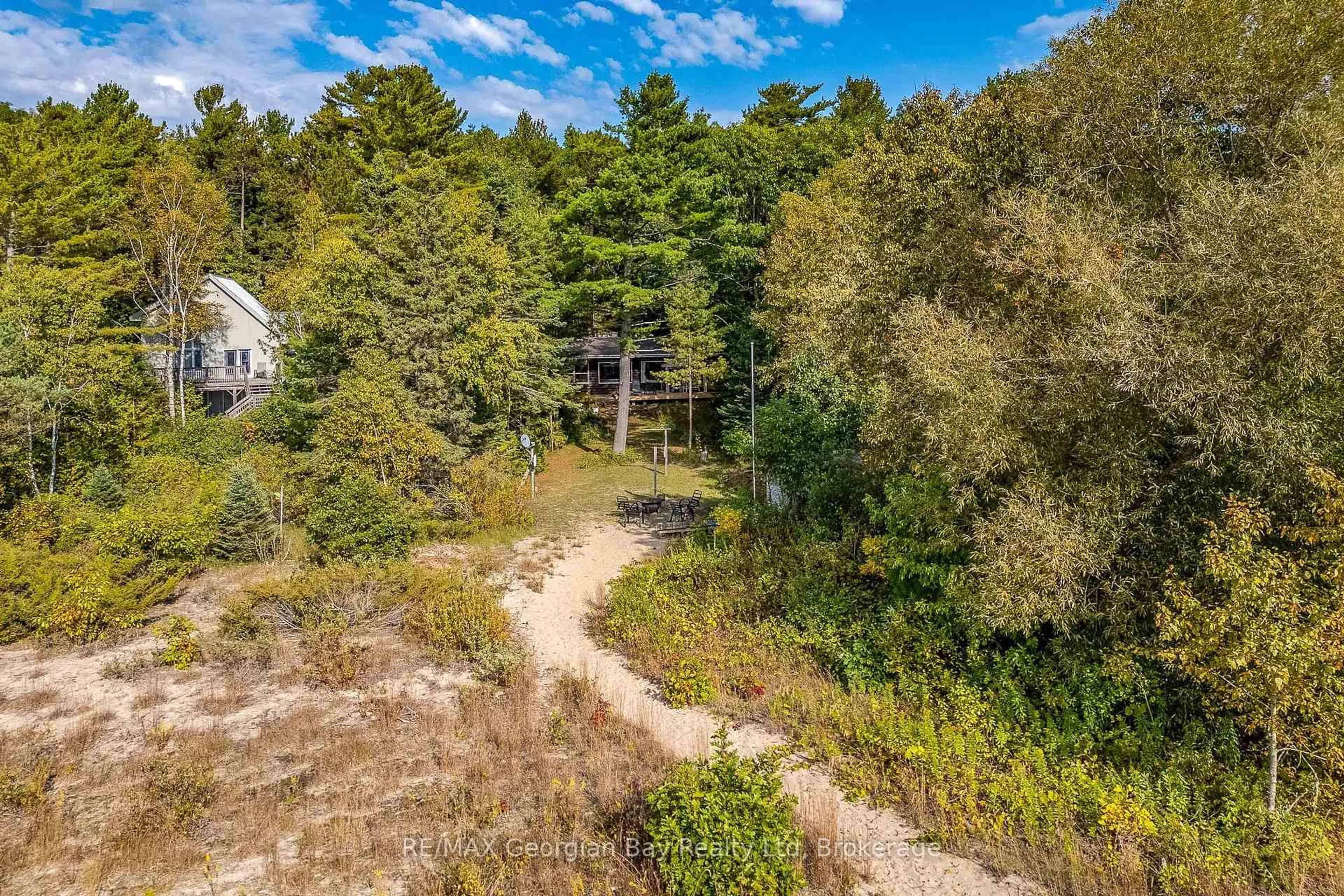 A pic from outside/outdoor area/front of a property/back of a property/a pic from drone, forest/trees view for 100 Nottawaga Dr, Tiny Ontario L0L 2J0