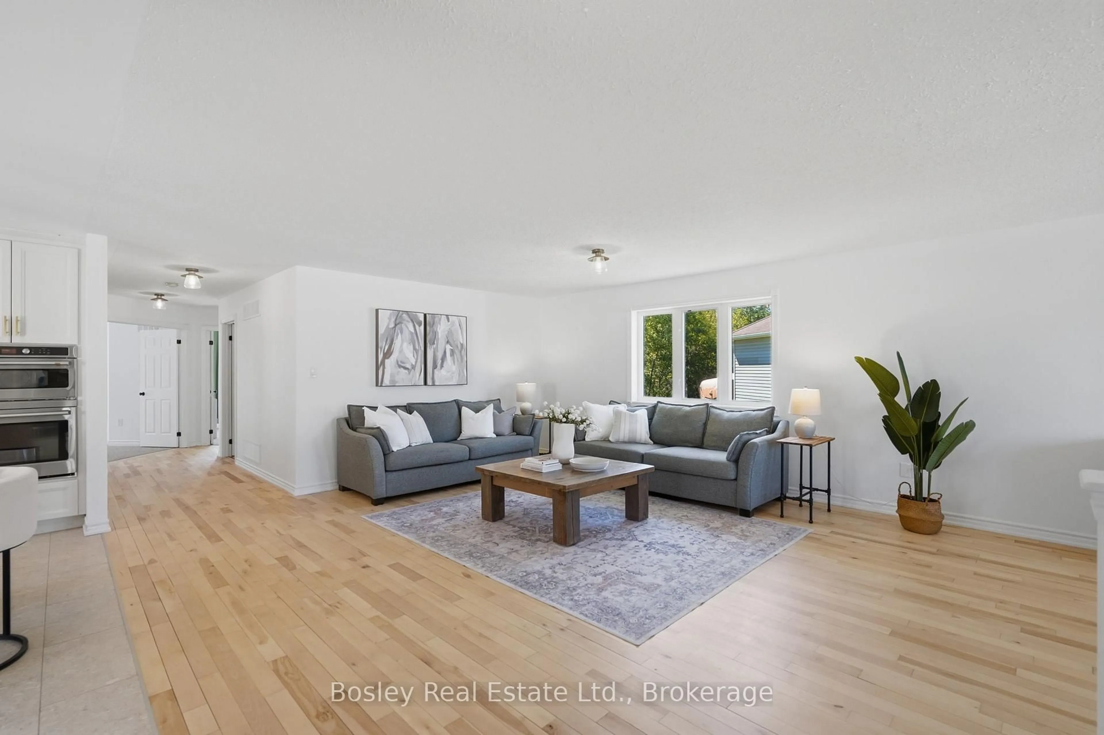 Living room with furniture, wood/laminate floor for 208 Lamont Crt, Clearview Ontario L0M 1S0