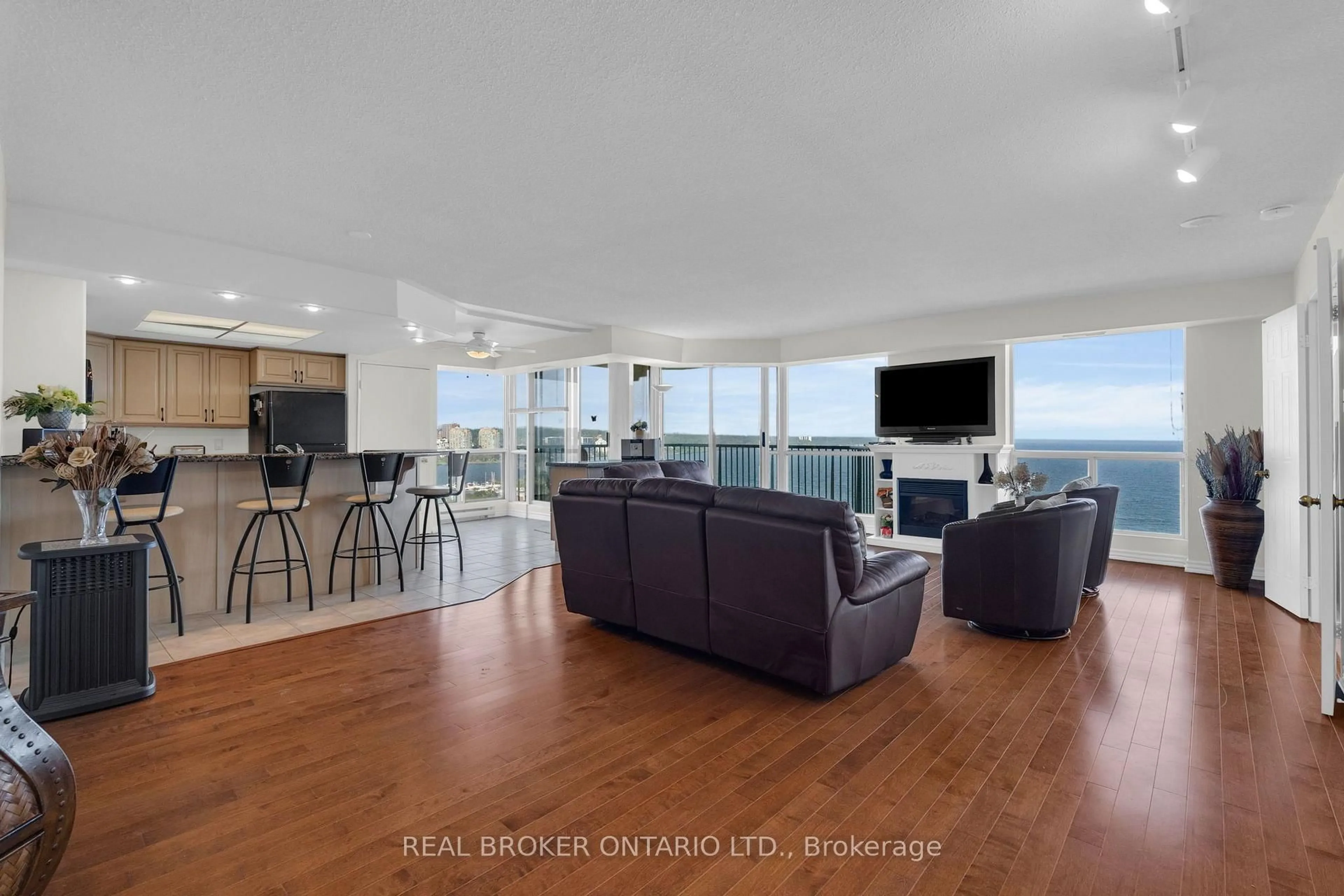 Living room with furniture, wood/laminate floor for 65 Ellen St #903, Barrie Ontario L4N 3A5