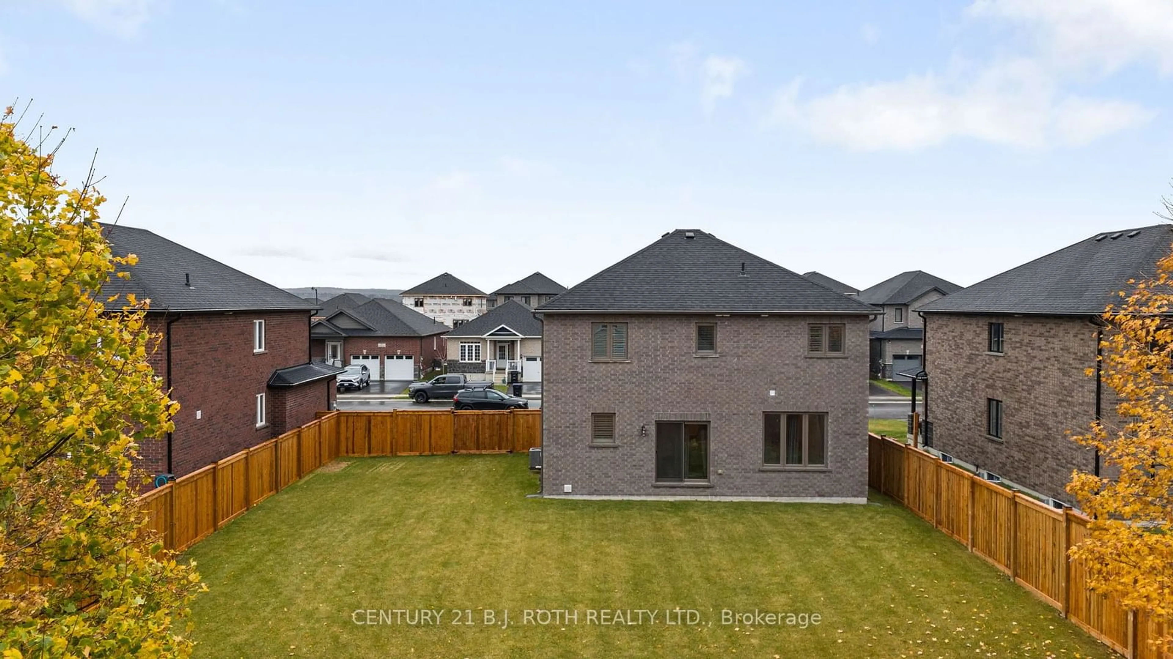 Frontside or backside of a home, the fenced backyard for 20 Rowley Cres, Springwater Ontario L0L 1P0