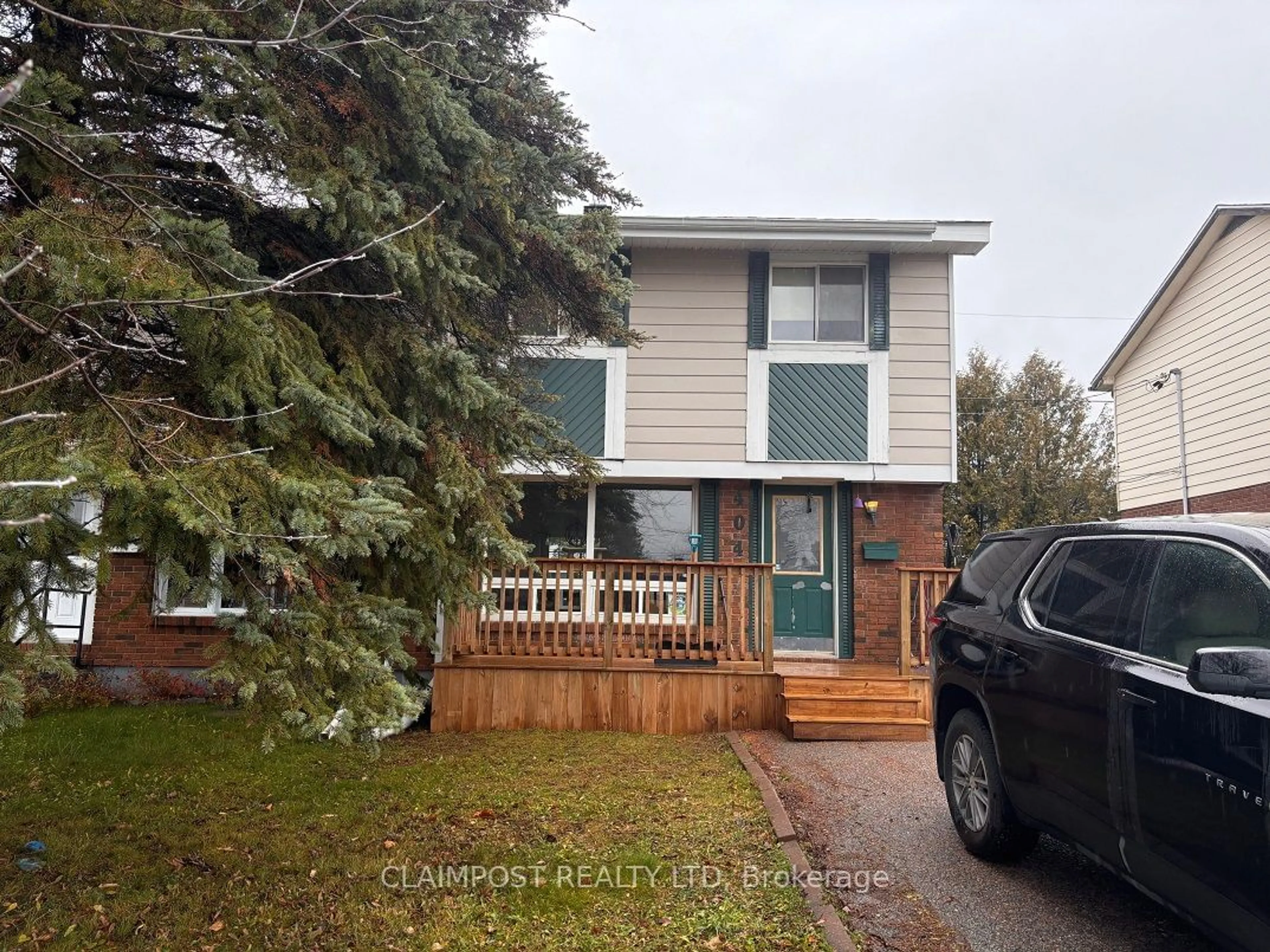 Frontside or backside of a home, the fenced backyard for 404 Louise Ave, Timmins Ontario P4N 7Y6