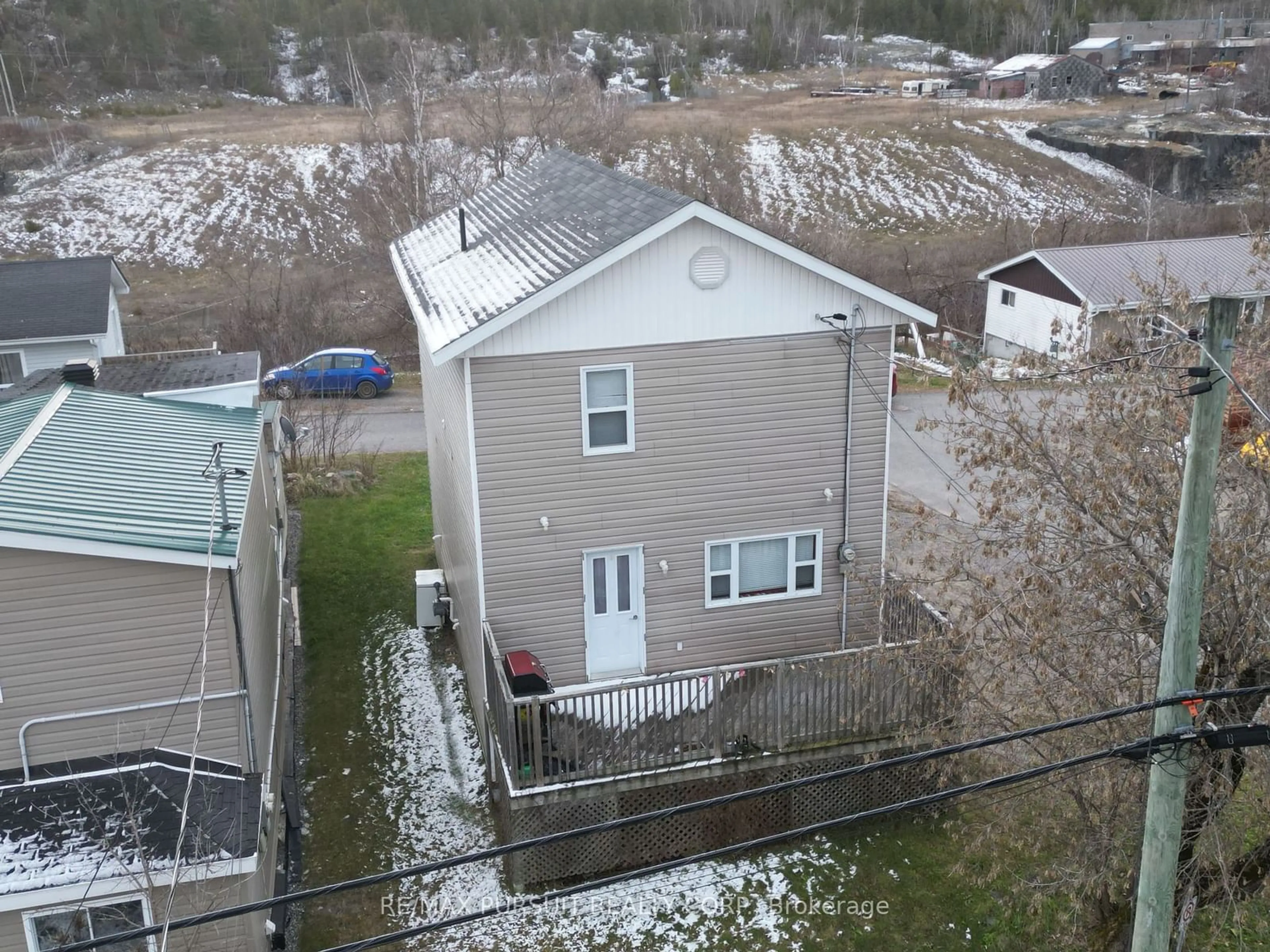 Frontside or backside of a home, the fenced backyard for 187 Lang St, Cobalt Ontario P0J 1C0