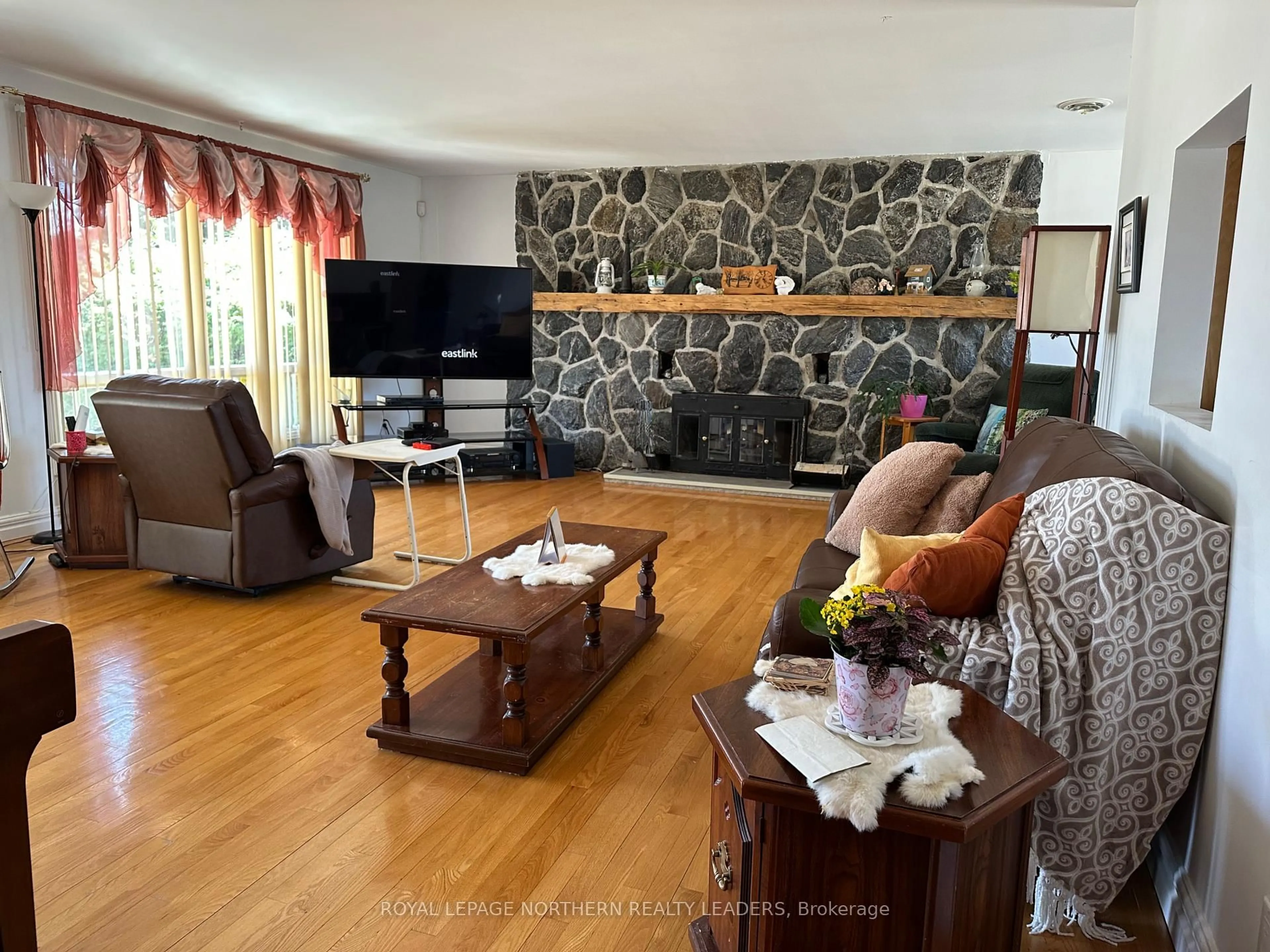 Living room with furniture, wood/laminate floor for 135 Marcel Ave, Timmins Ontario P4R 1H1