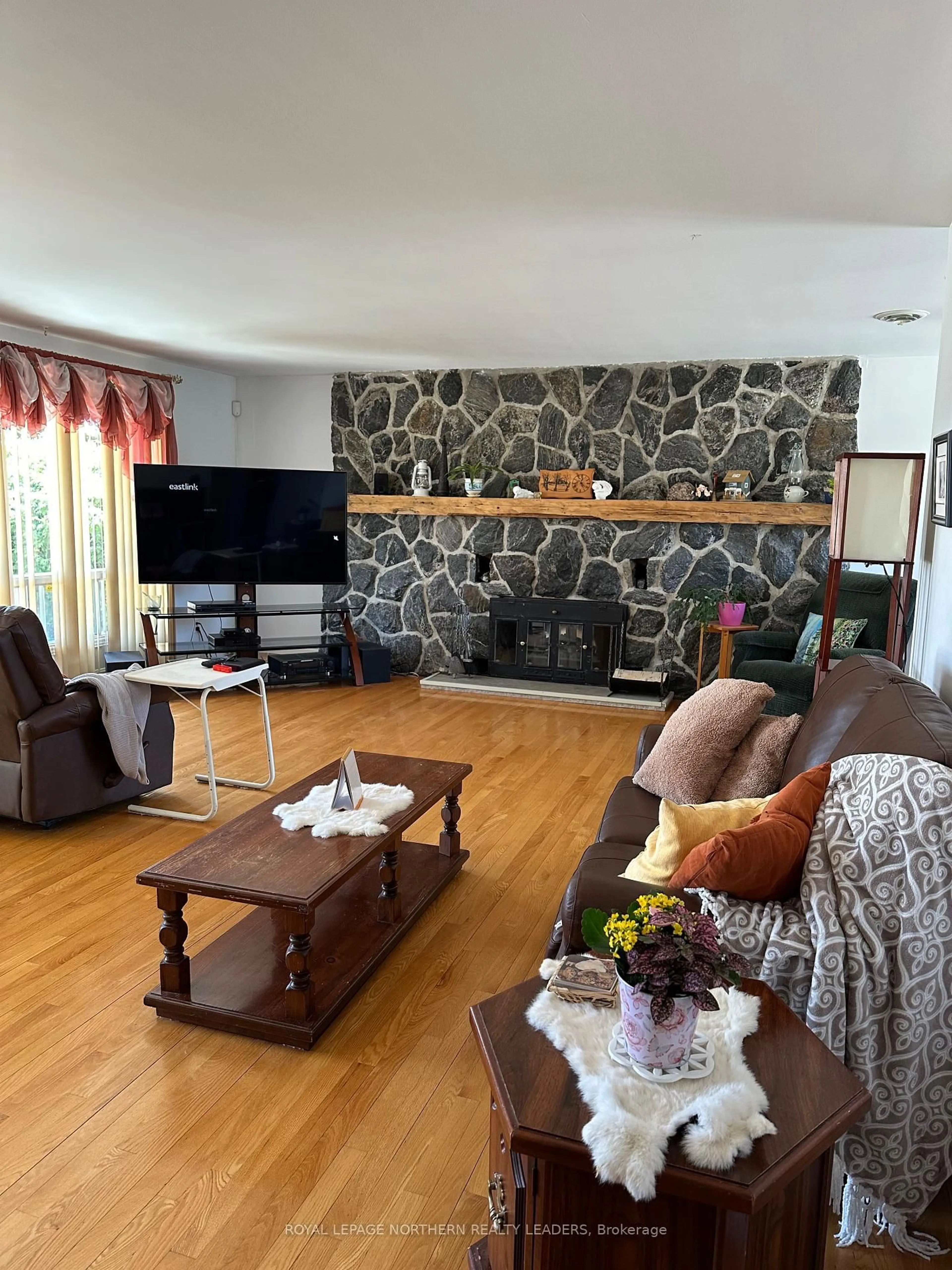 Living room with furniture, wood/laminate floor for 135 Marcel Ave, Timmins Ontario P4R 1H1