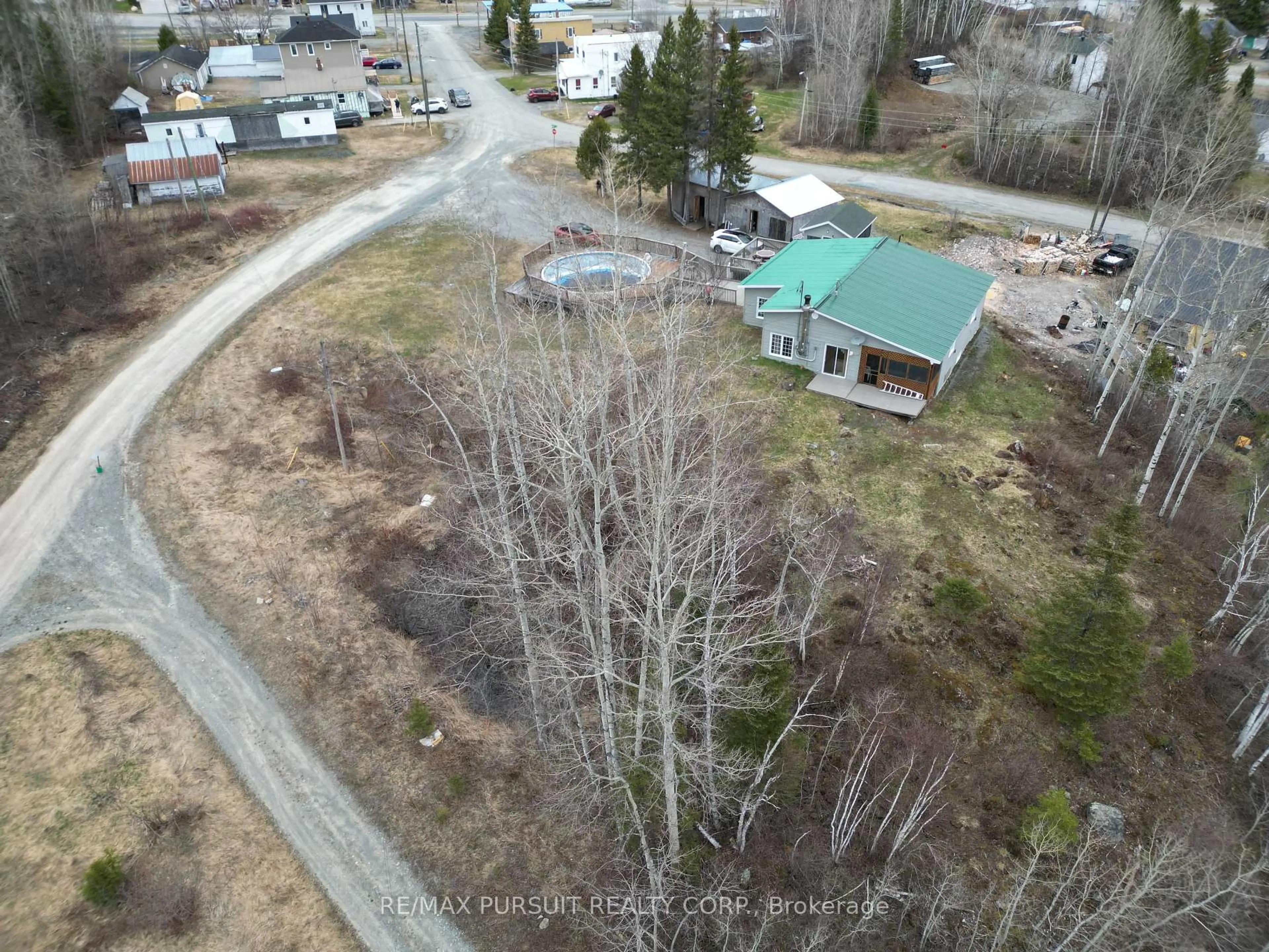 A pic from outside/outdoor area/front of a property/back of a property/a pic from drone, forest/trees view for 8 Townsley Ave, Timiskaming Ontario P0K 1X0