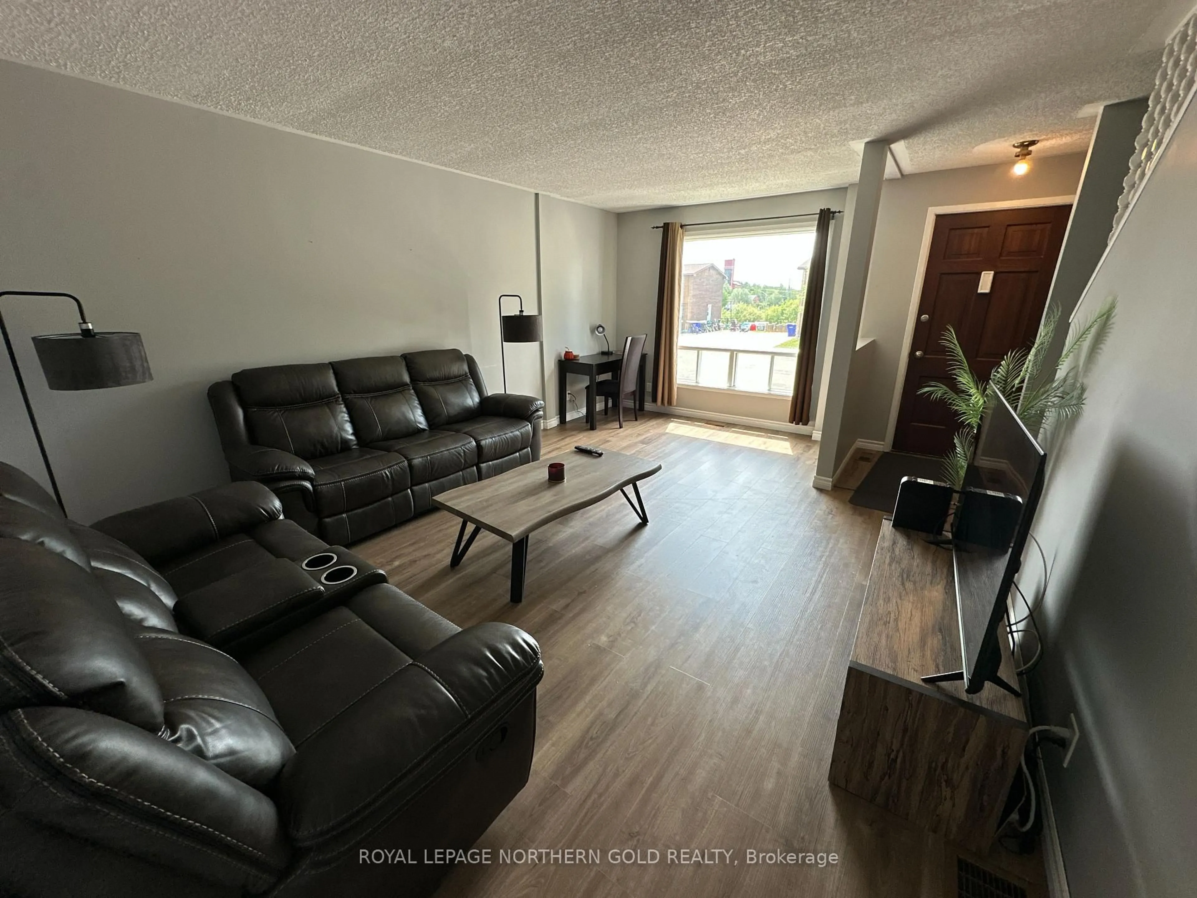 Living room with furniture, wood/laminate floor for 76 HARDING Ave, Kirkland Lake Ontario P2N 3N3