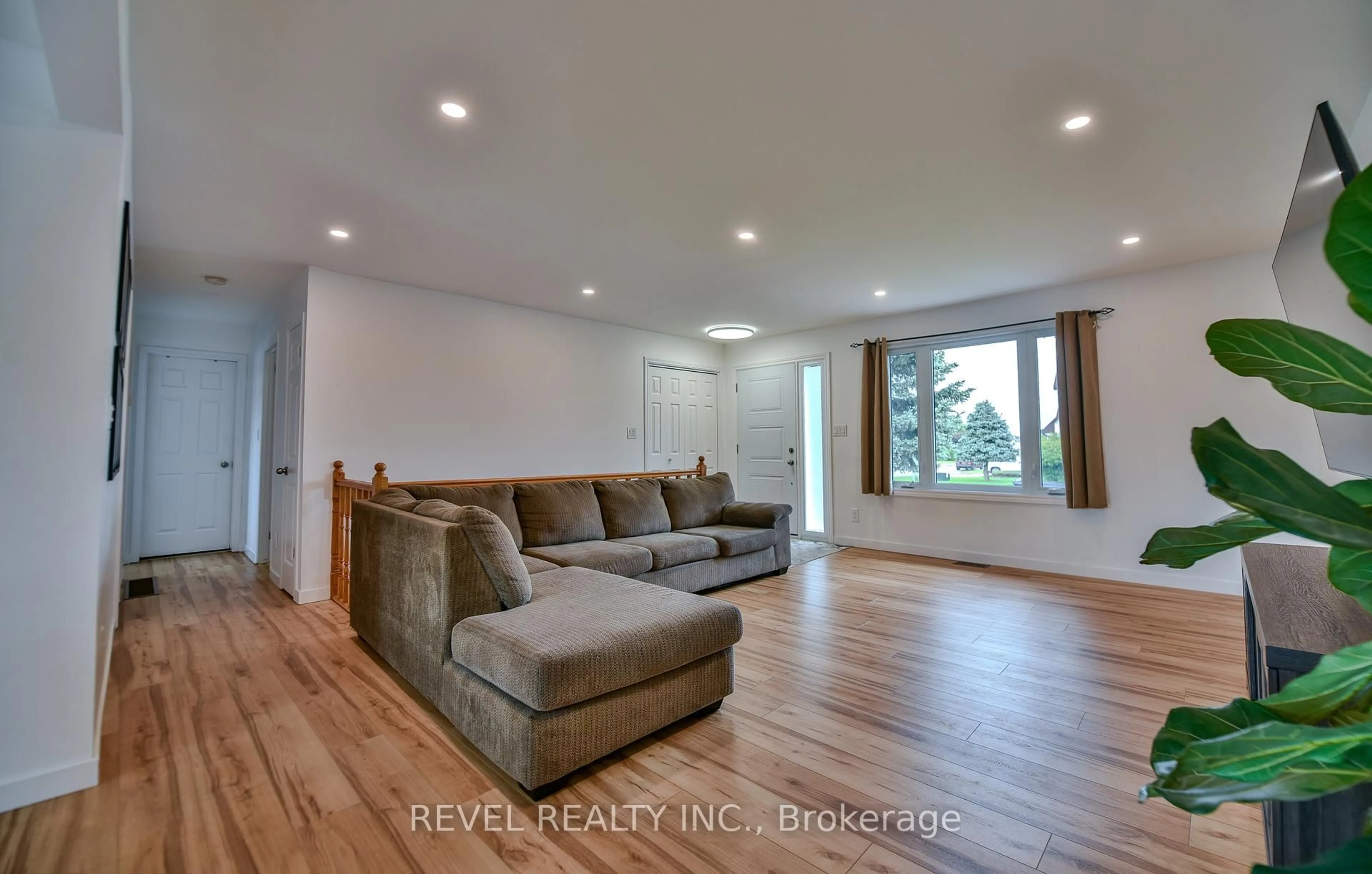 Living room with furniture, wood/laminate floor for 222 Laurentian Cres, Timmins Ontario P4R 1J9