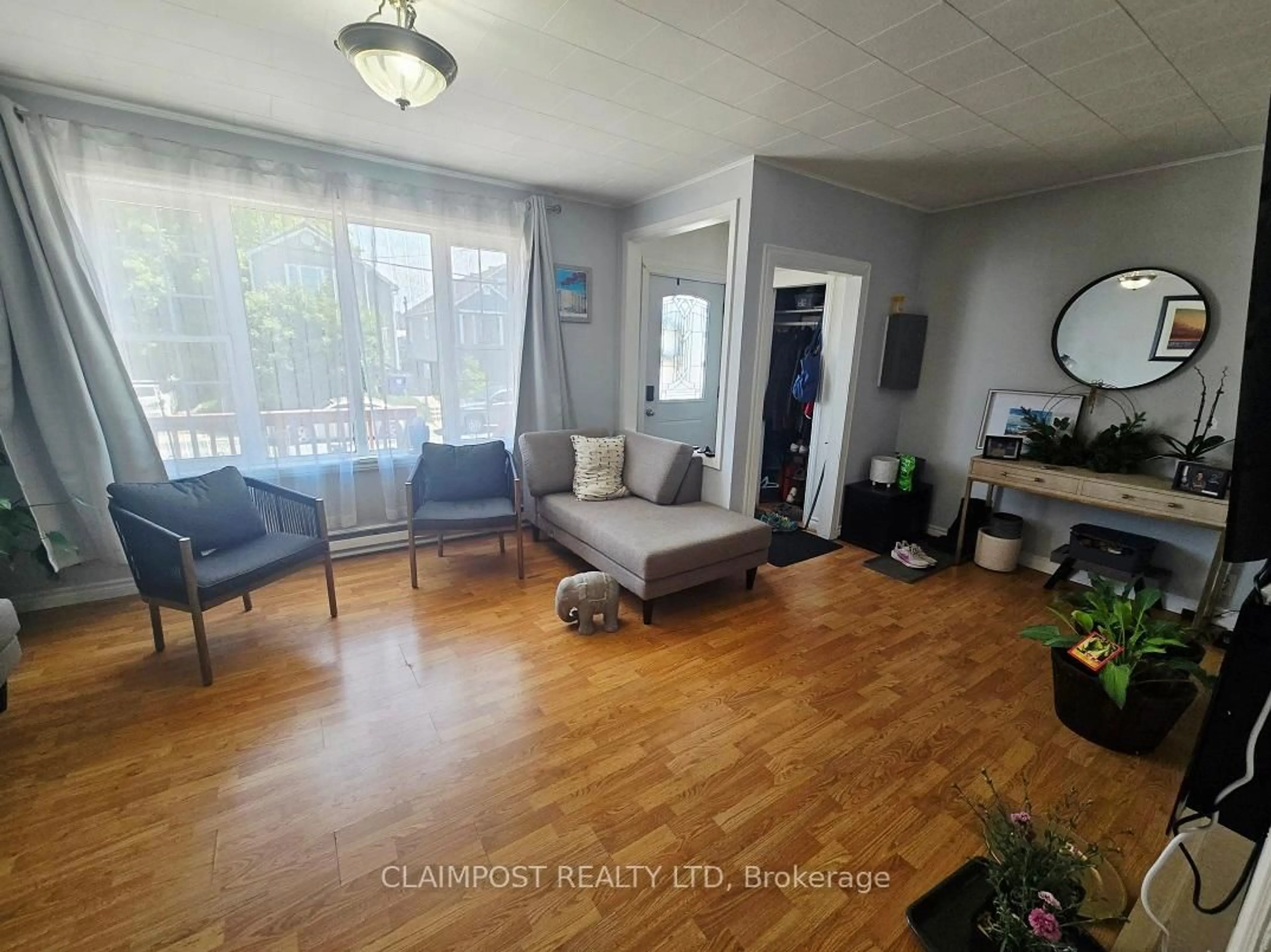 Living room with furniture, wood/laminate floor for 273 Maple St, Timmins Ontario P4N 6C2