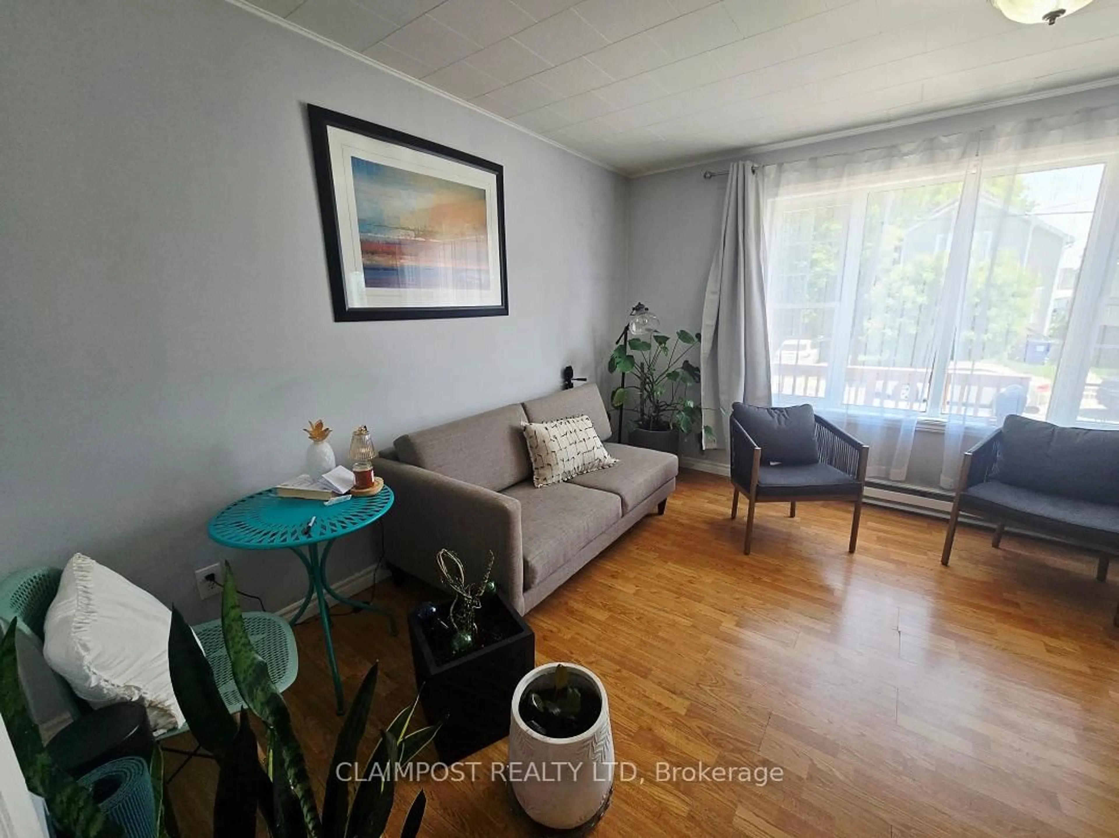 Living room with furniture, wood/laminate floor for 273 Maple St, Timmins Ontario P4N 6C2