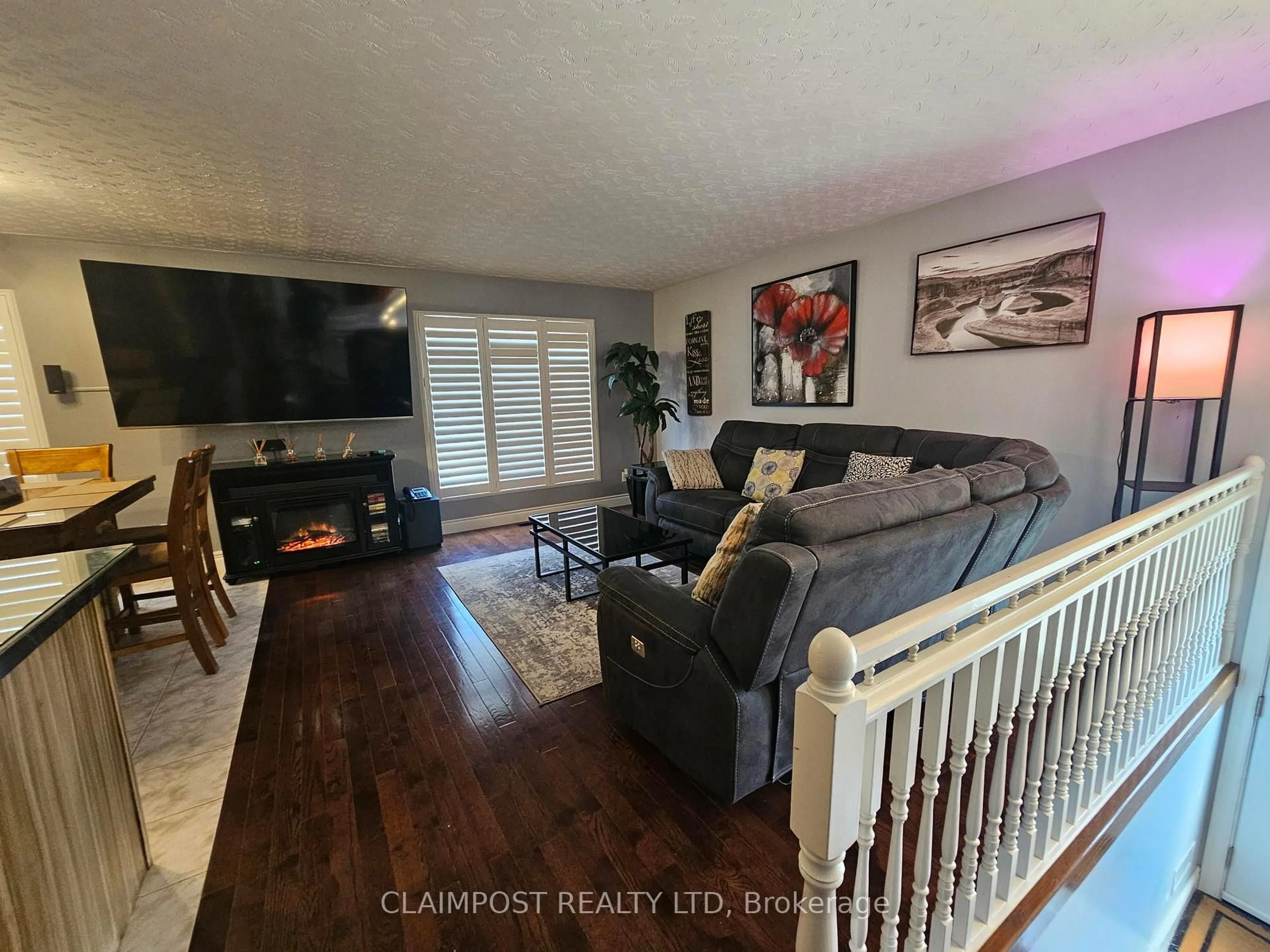 Living room with furniture, wood/laminate floor for 253 Way Ave, Timmins Ontario P4N 3C8