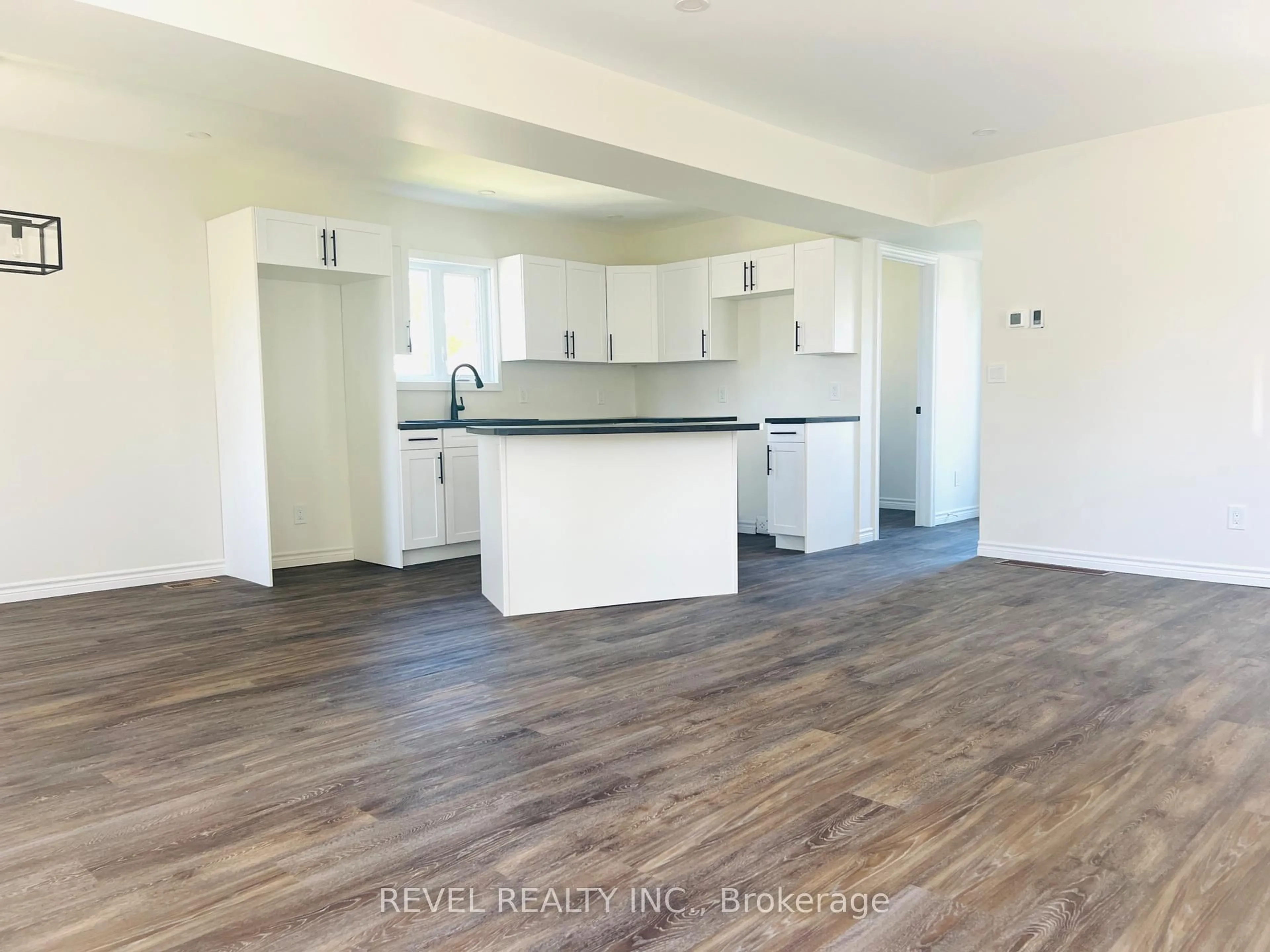 Open concept kitchen, wood/laminate floor for 66 O'Brian Ave, Timmins Ontario P0N 1H0