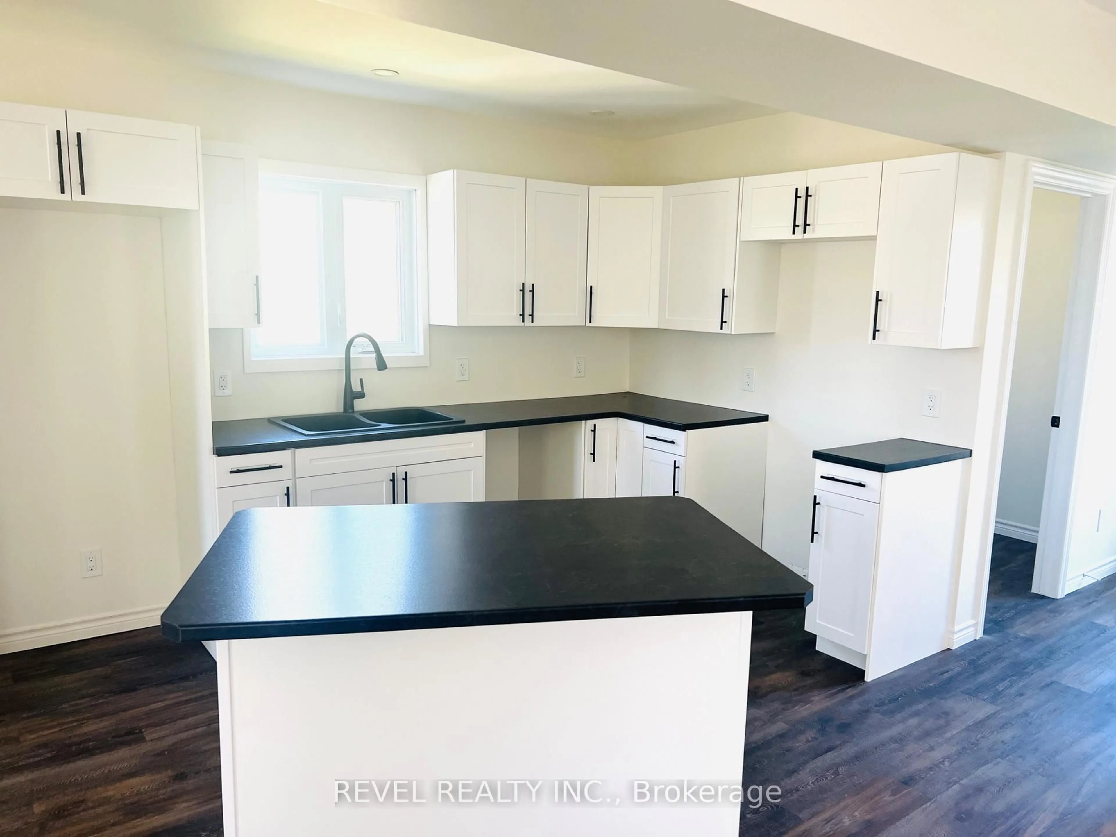 Open concept kitchen, wood/laminate floor for 66 O'Brian Ave, Timmins Ontario P0N 1H0