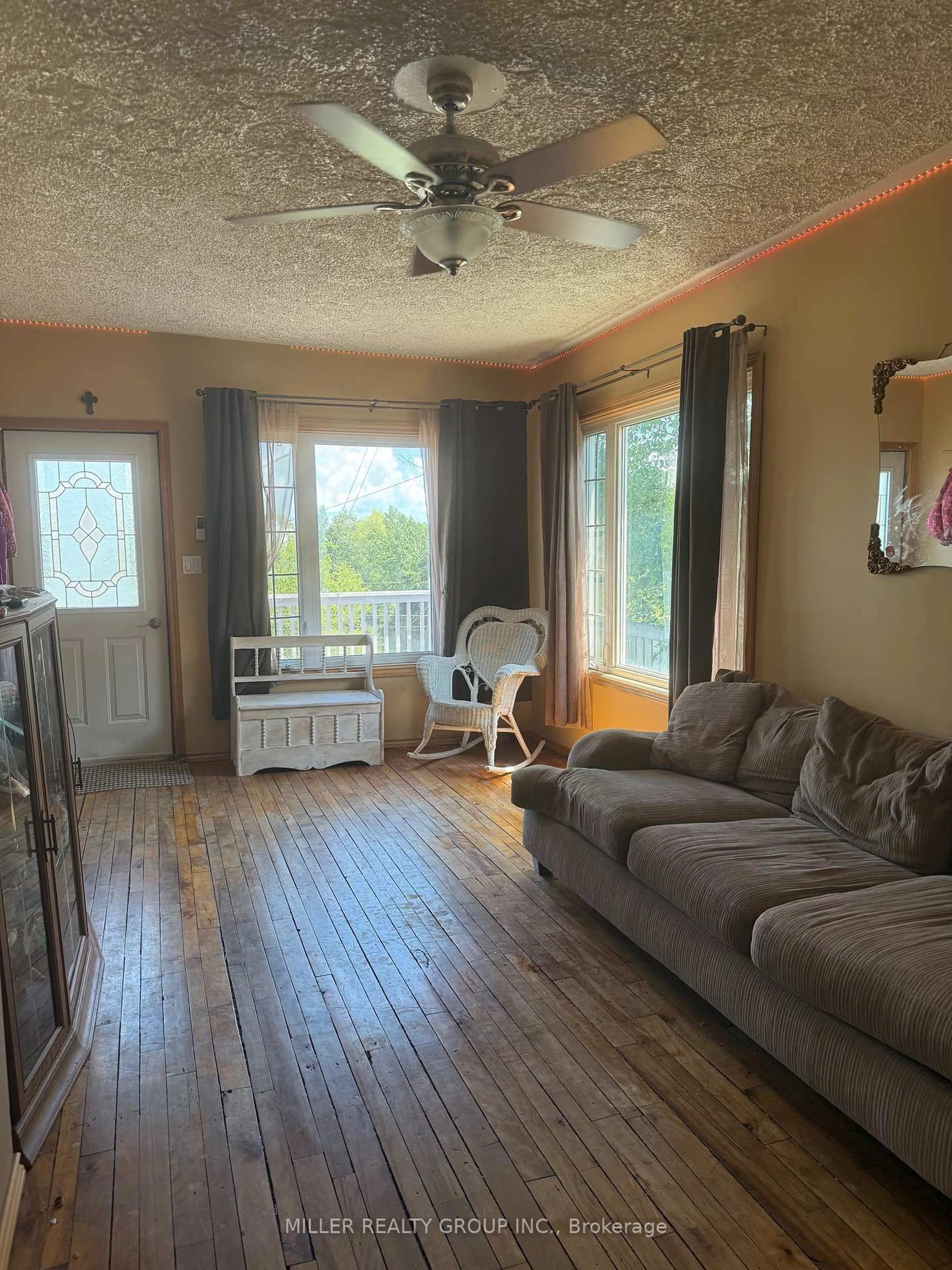 Living room with furniture, wood/laminate floor for 66 Silver St, Cobalt Ontario P0J 1C0