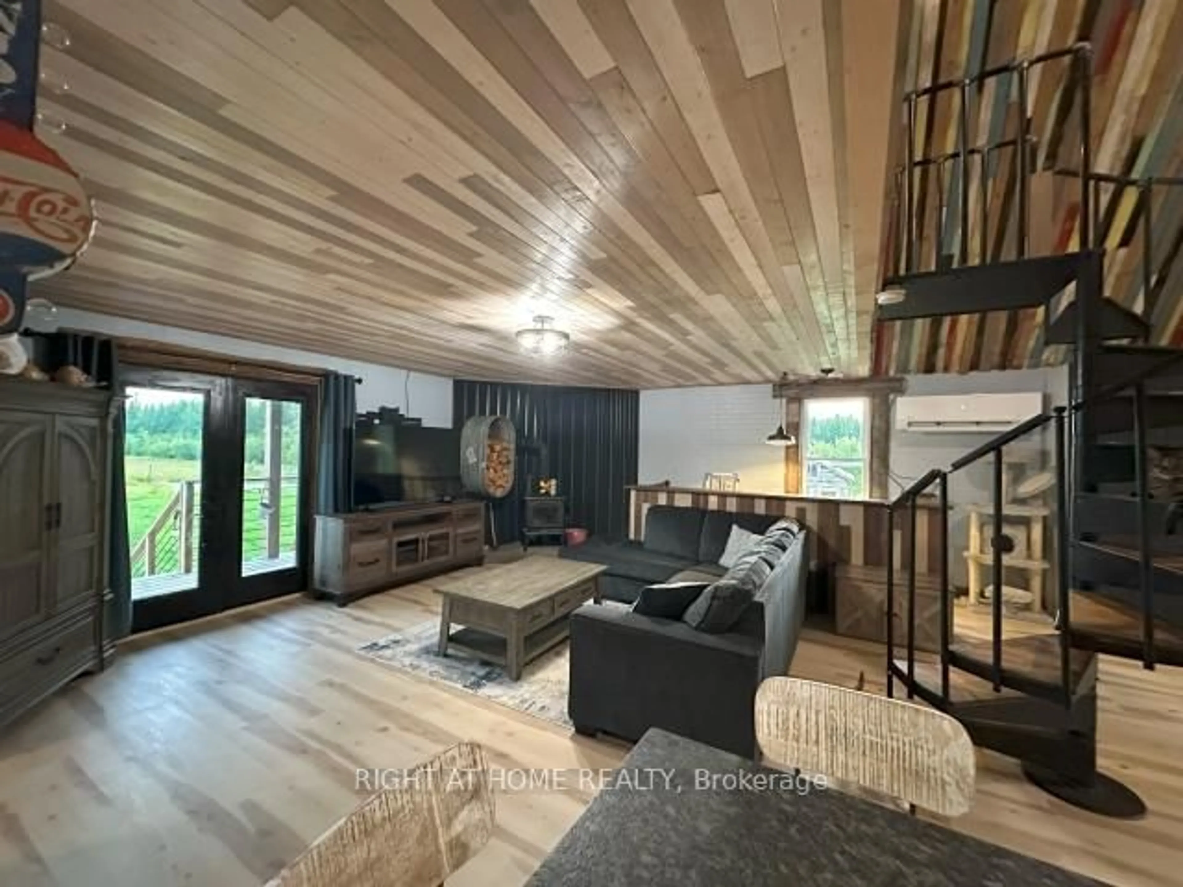 Living room with furniture, wood/laminate floor for 680 Peltola Rd, Cochrane Ontario P0L 1C0