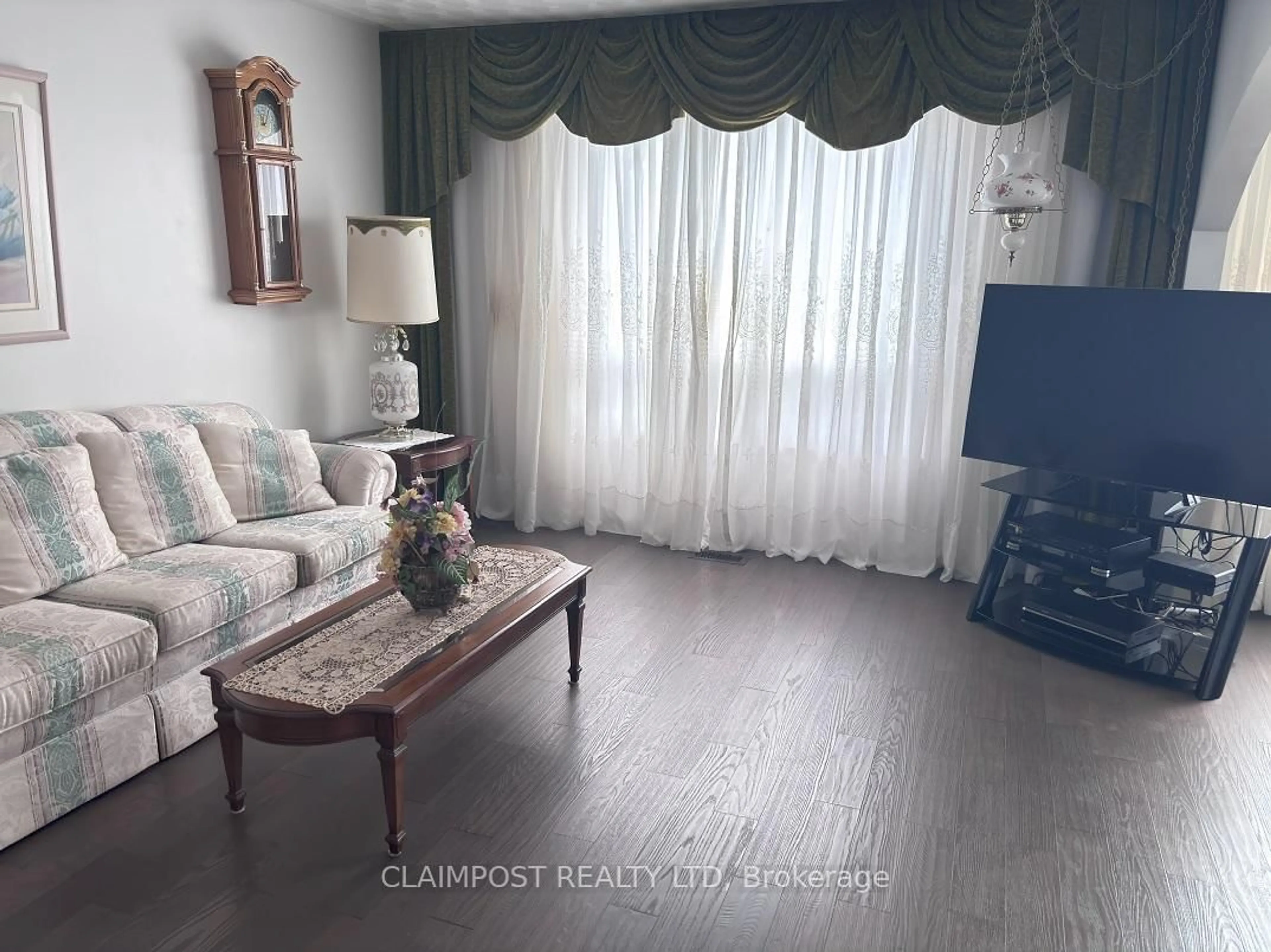 Living room with furniture, wood/laminate floor for 172 Huot St, Timmins Ontario P0N 1H0