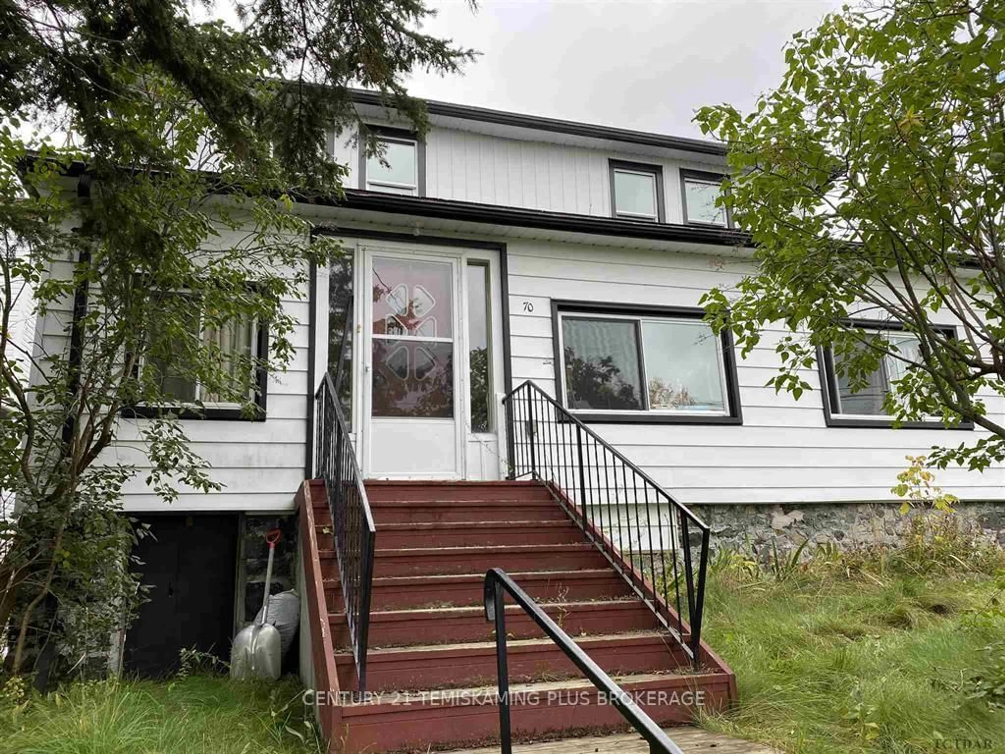 Home with vinyl exterior material, street for 70 Nickle St, Cobalt Ontario P0J 1C0