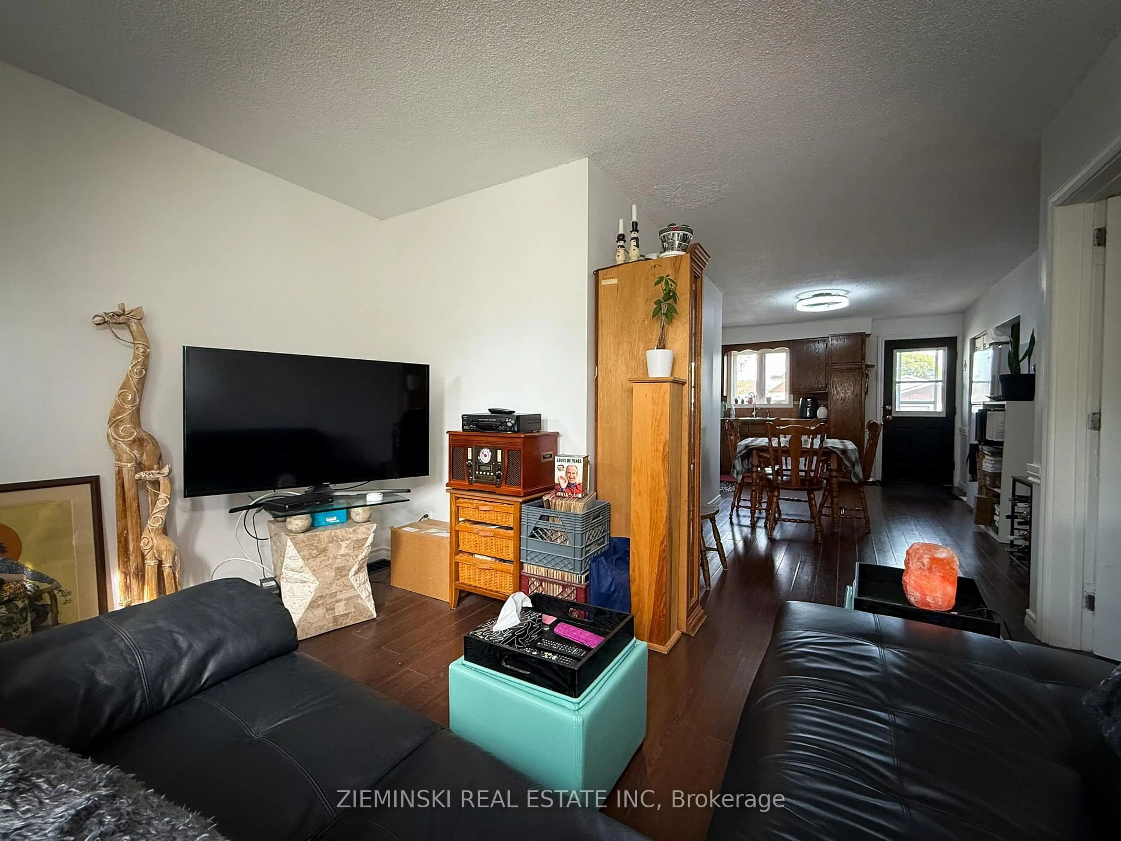 Living room with furniture, wood/laminate floor for 18 Laurier Ave, Timmins Ontario P4N 4G5