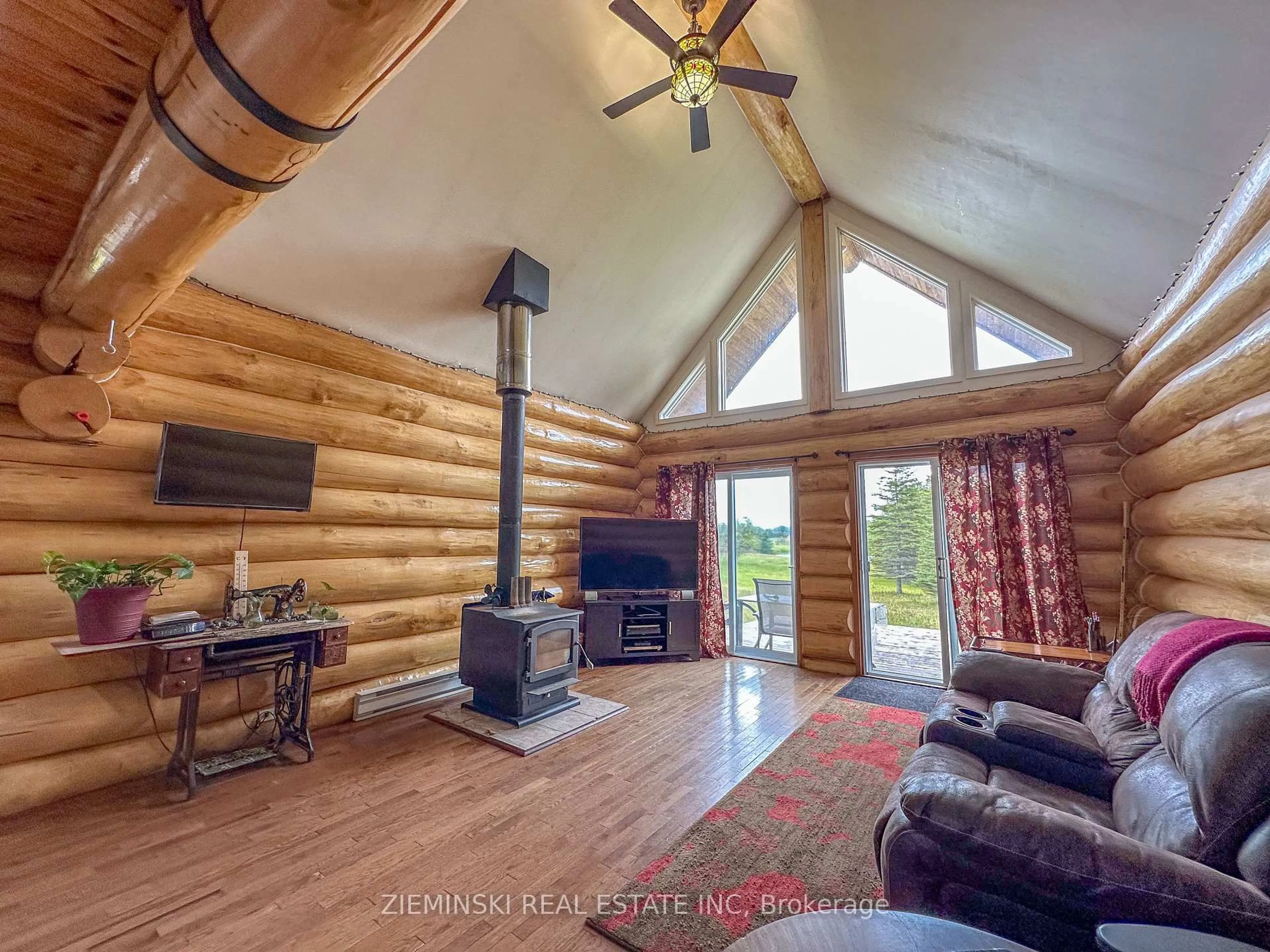 Living room with furniture, wood/laminate floor for 4621 Frederick House Lake Rd, Timmins Ontario P0N 1A0