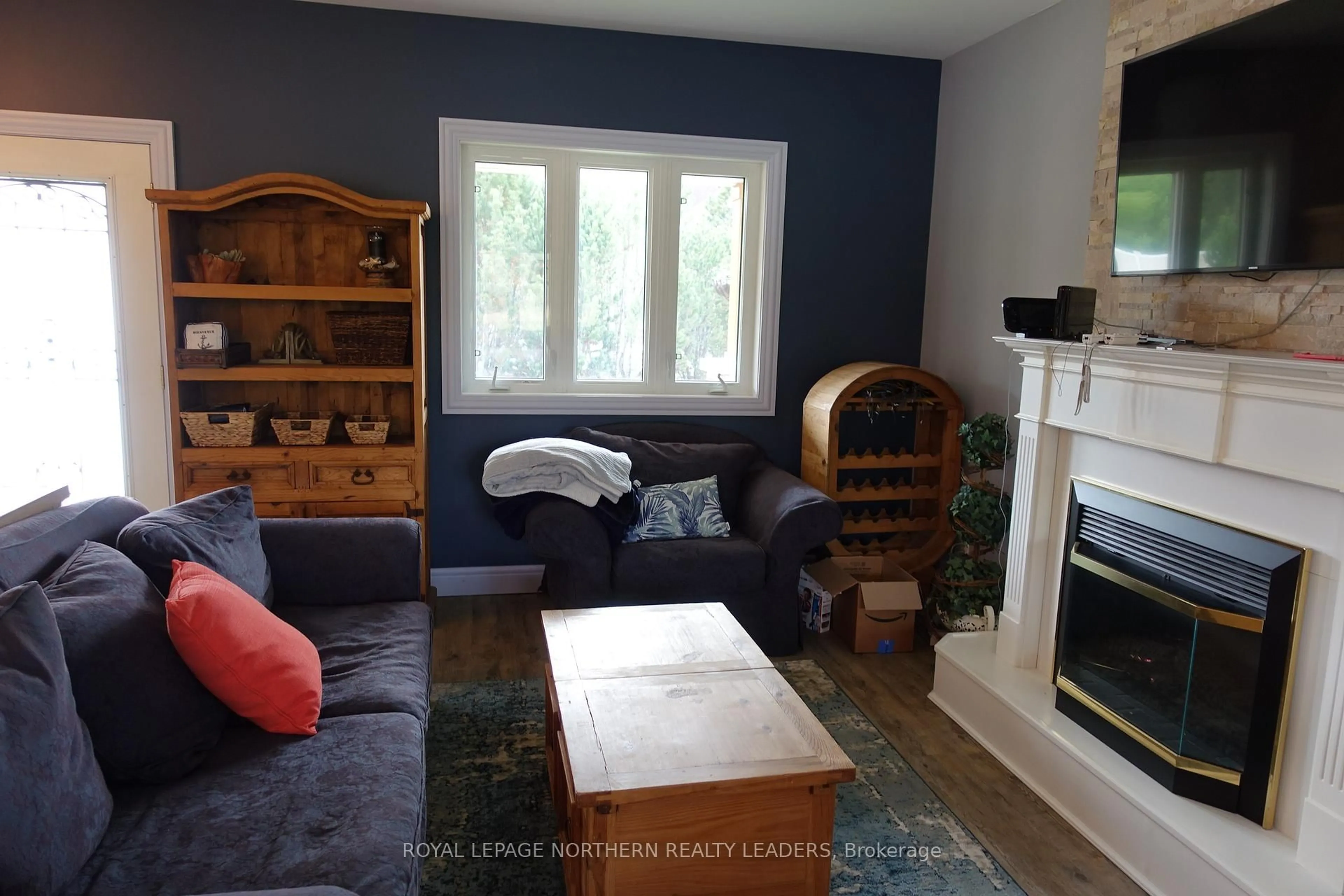 Living room with furniture, wood/laminate floor for 1900 Sandy Falls Rd, Timmins Ontario P4N 7C3