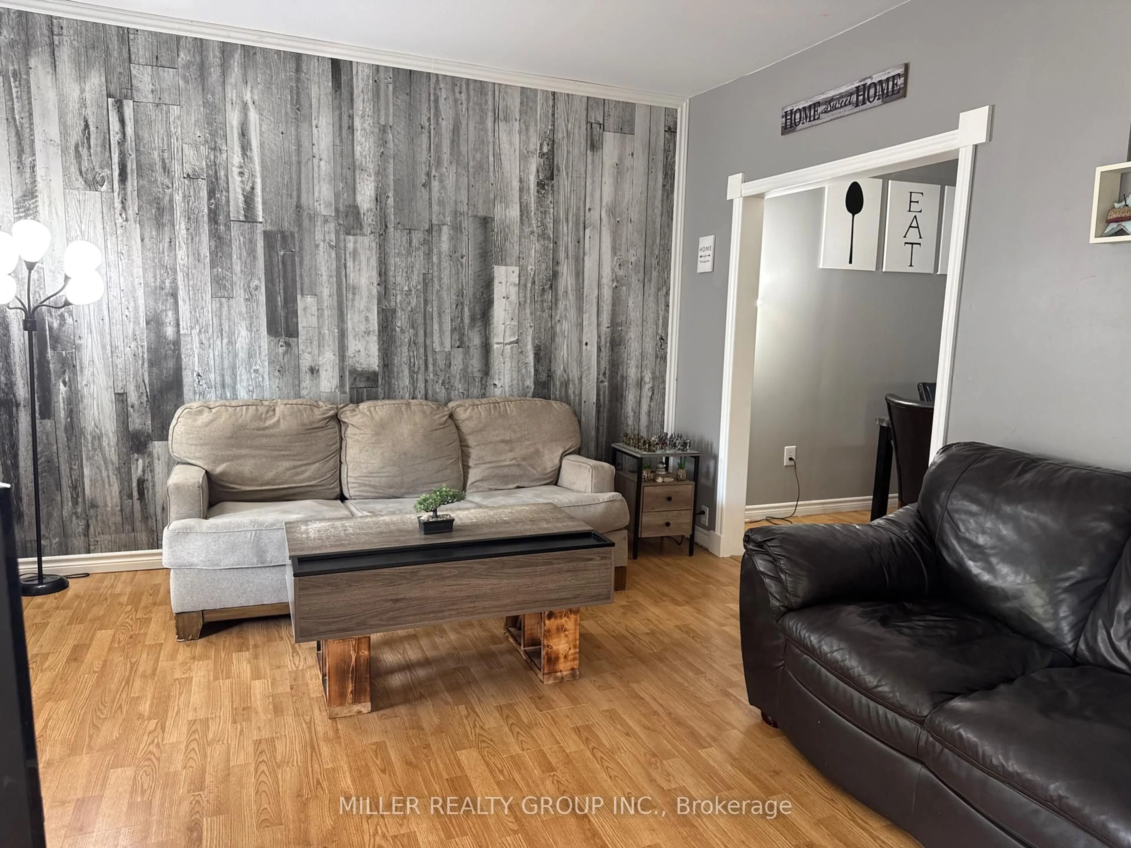 Living room with furniture, wood/laminate floor for 439 Browning St, Temiskaming Shores Ontario P0J 1K0