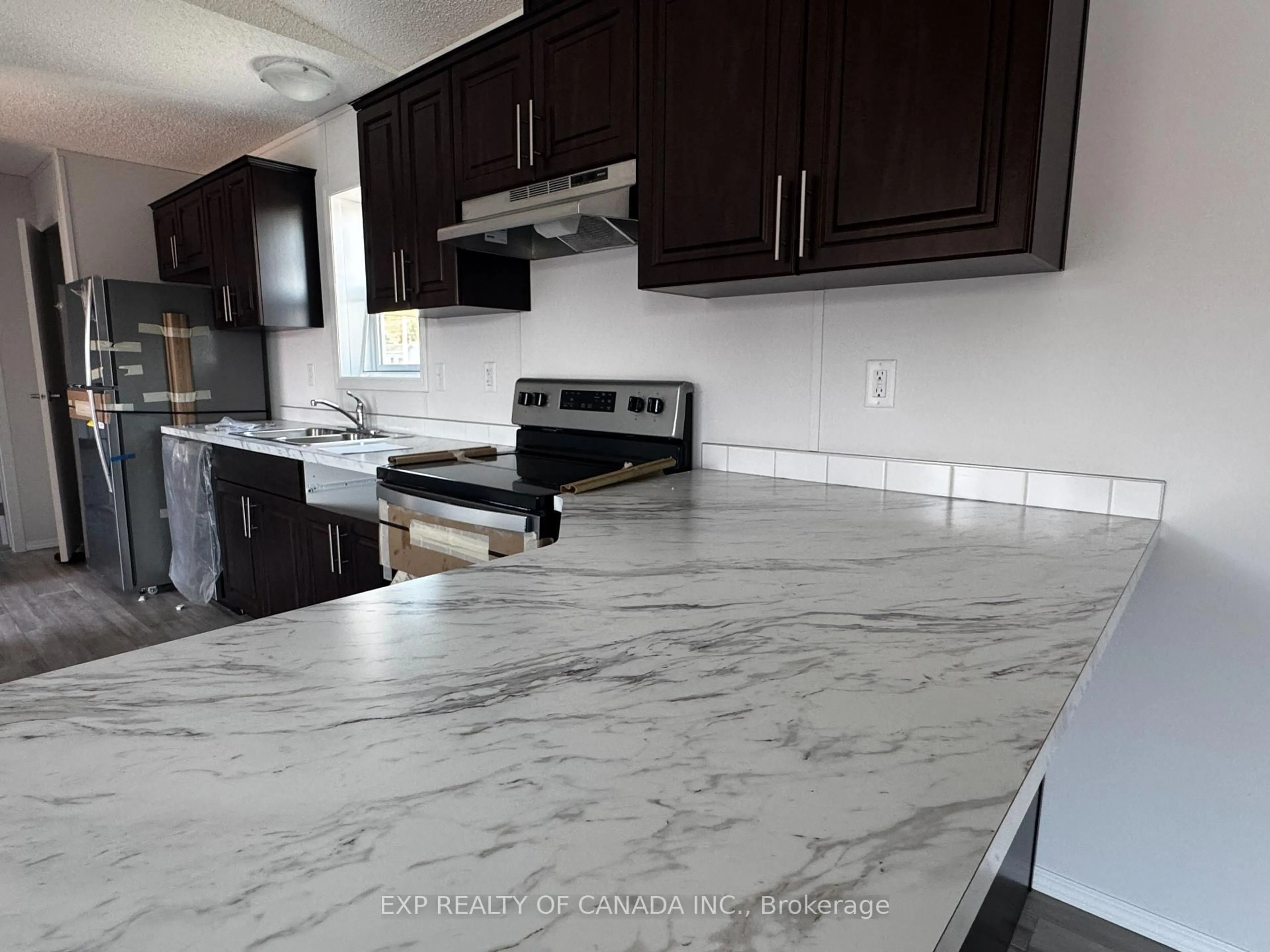 Open concept kitchen, ceramic/tile floor for 201 Remi Cres, Timmins Ontario P4N 0C5