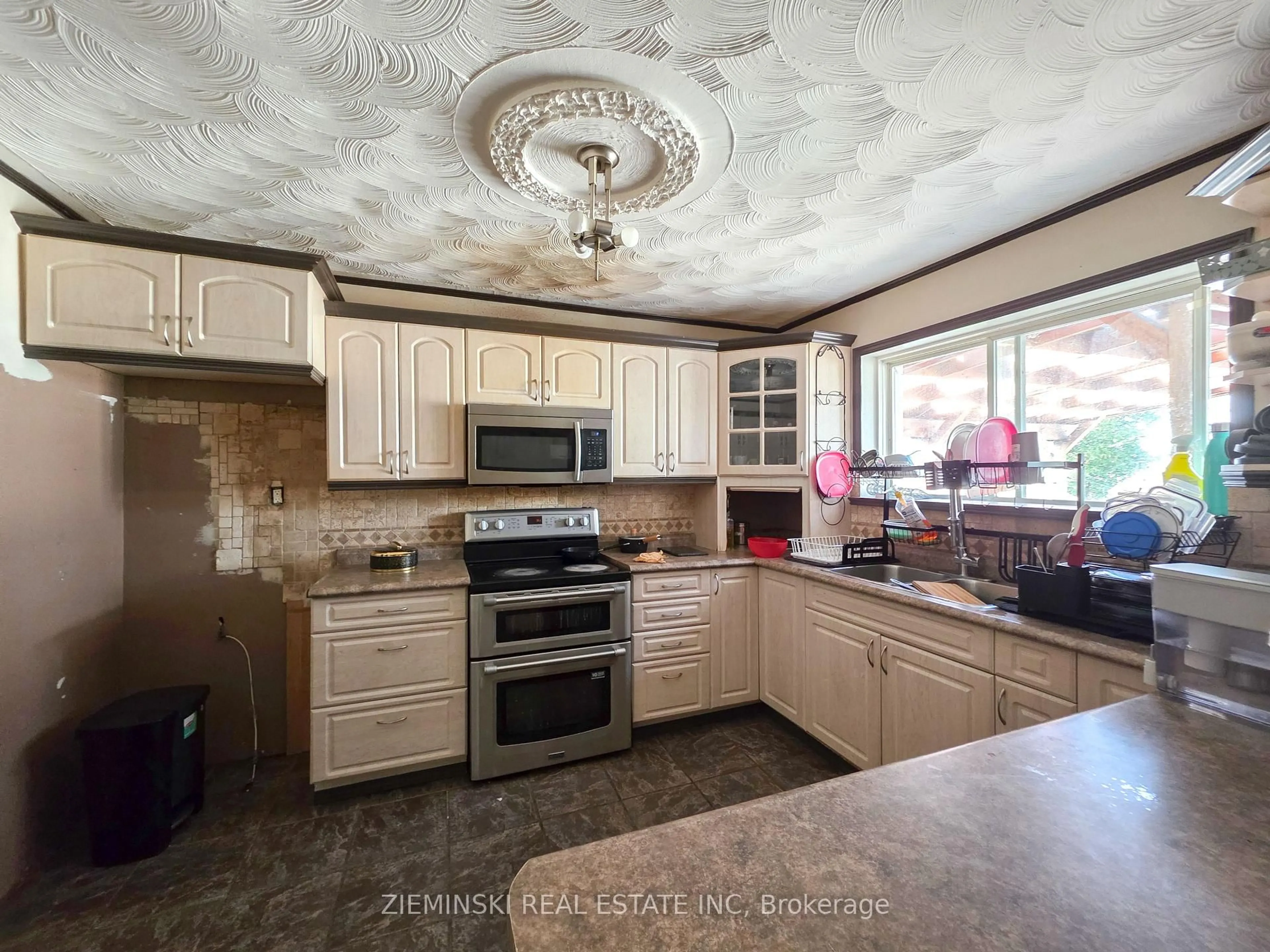 Open concept kitchen, ceramic/tile floor for 210 Commercial Ave, Timmins Ontario P4N 2X4