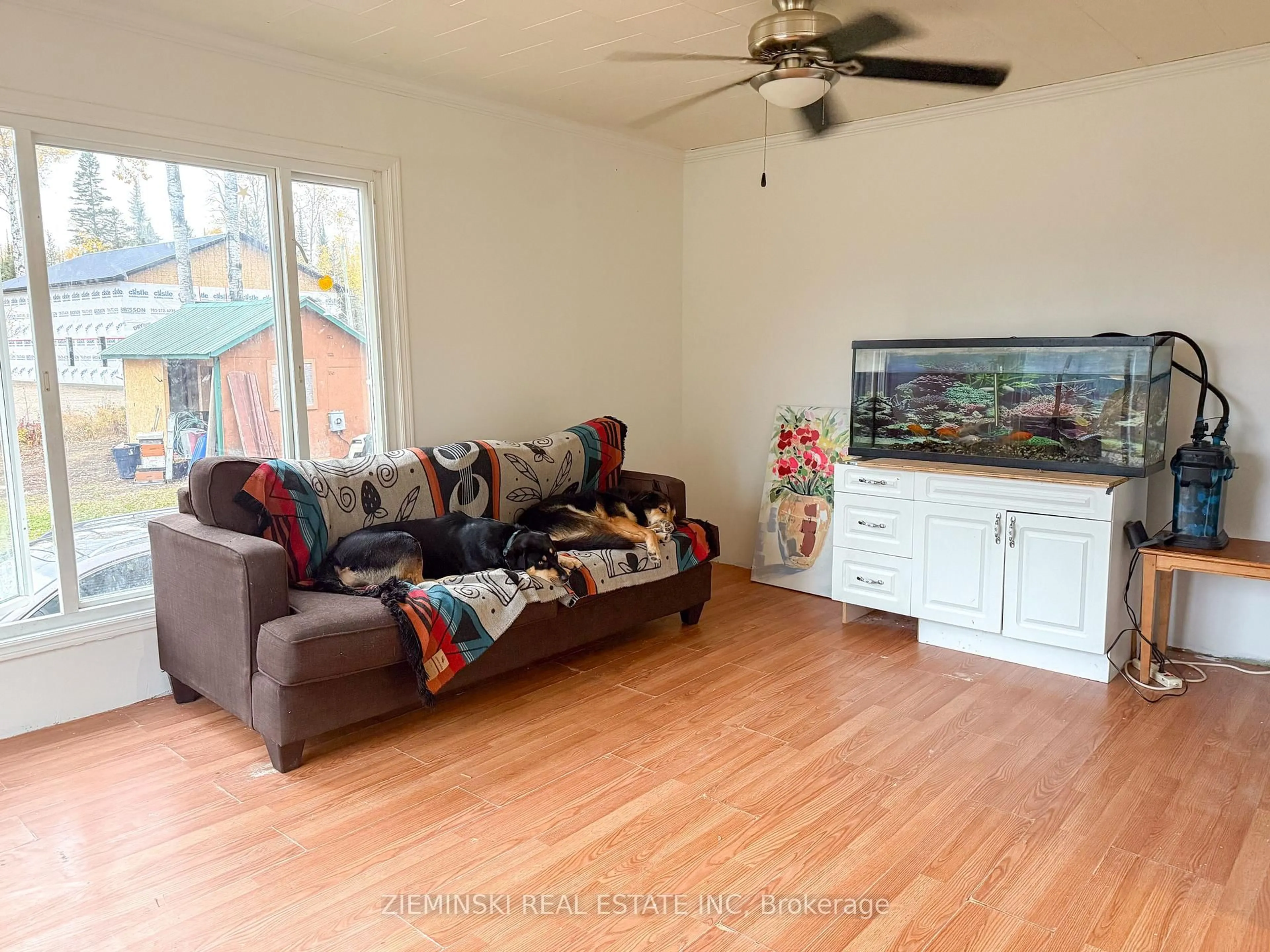 Living room with furniture, wood/laminate floor for 168 Nellie Lake Rd, Iroquois Falls Ontario P0K 1G0