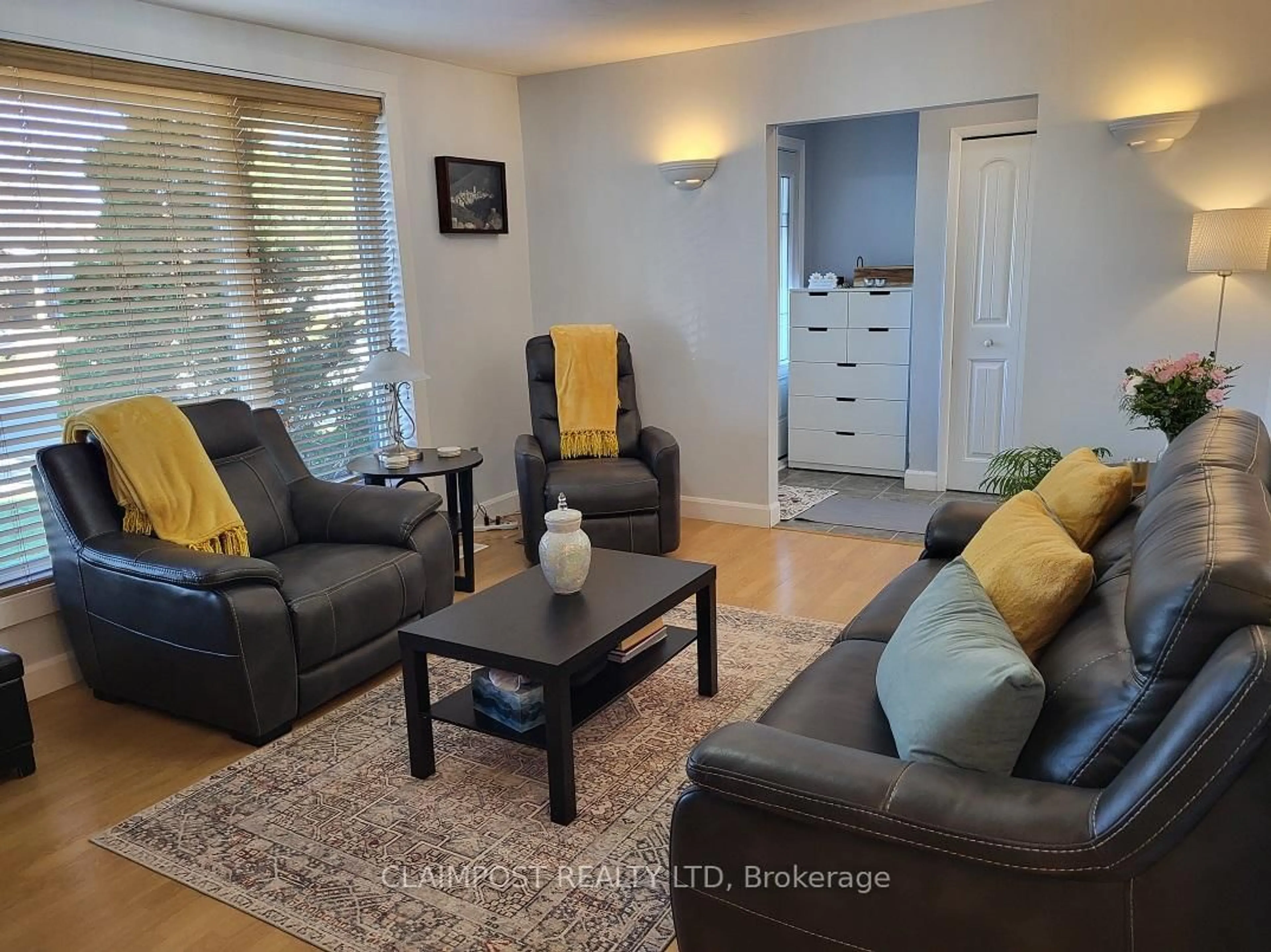 Living room with furniture, wood/laminate floor for 411 Ross Ave, Timmins Ontario P4N 5X4