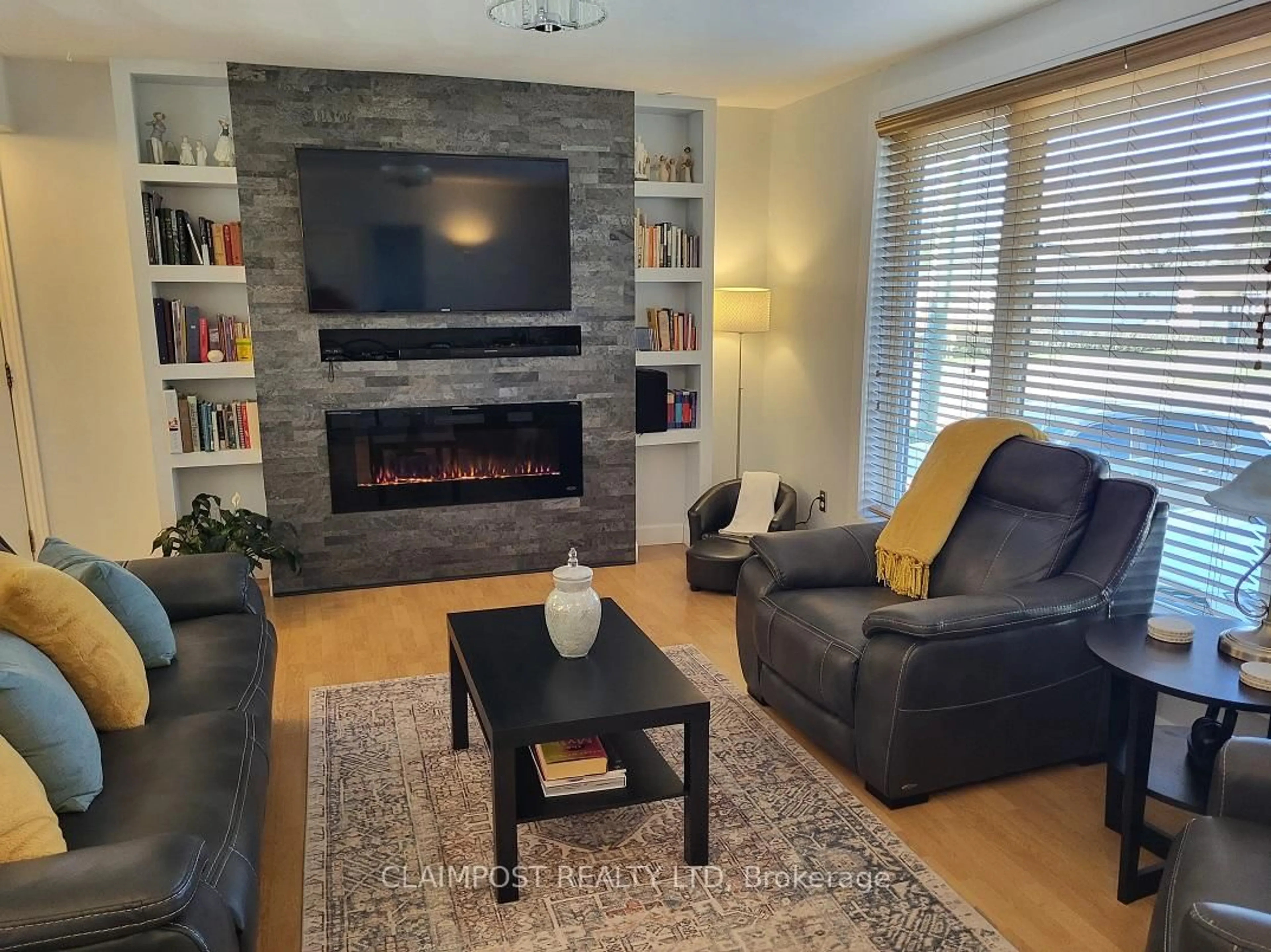 Living room with furniture, wood/laminate floor for 411 Ross Ave, Timmins Ontario P4N 5X4