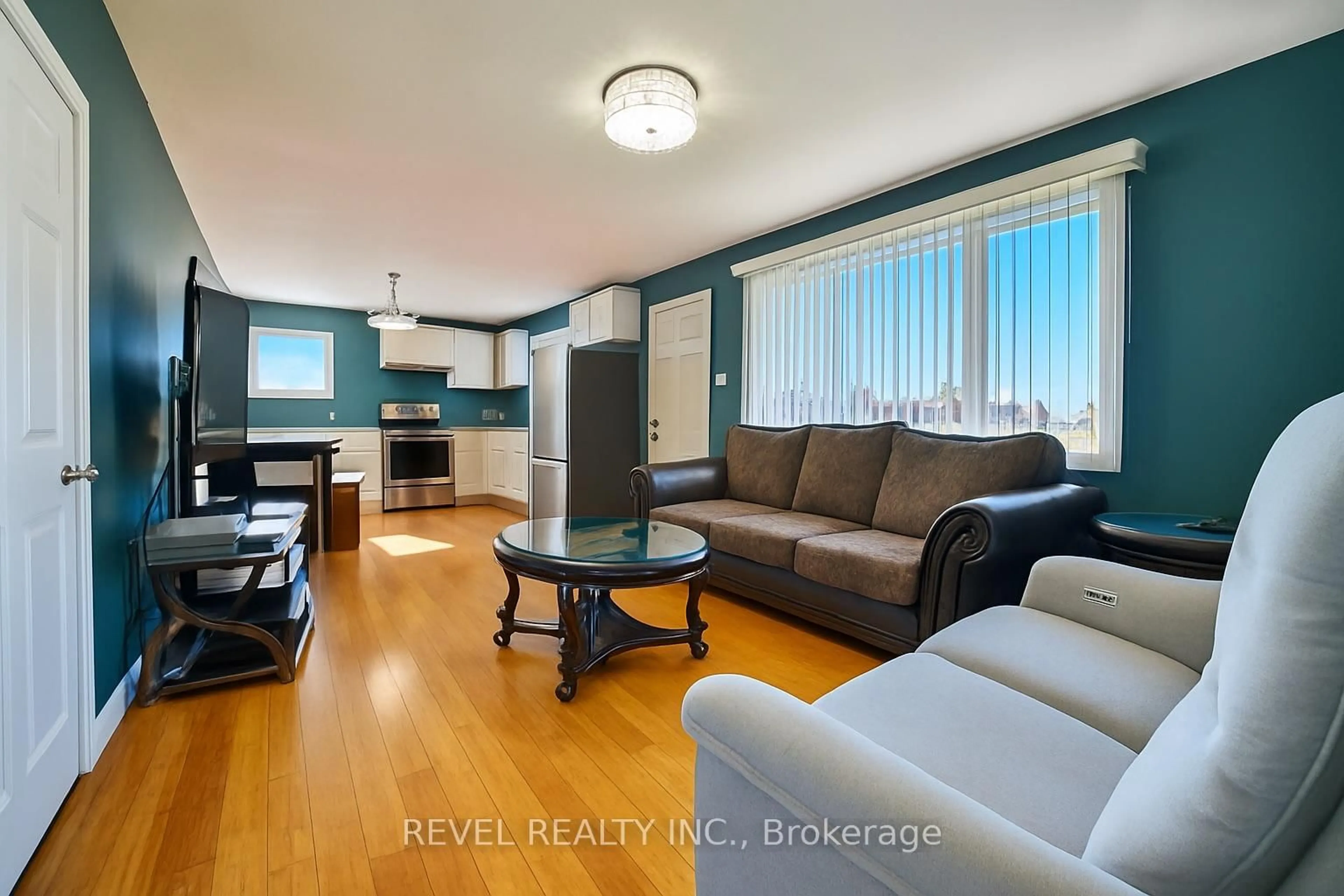 Living room with furniture, wood/laminate floor for 646 College St, Timmins Ontario P4N 5J8