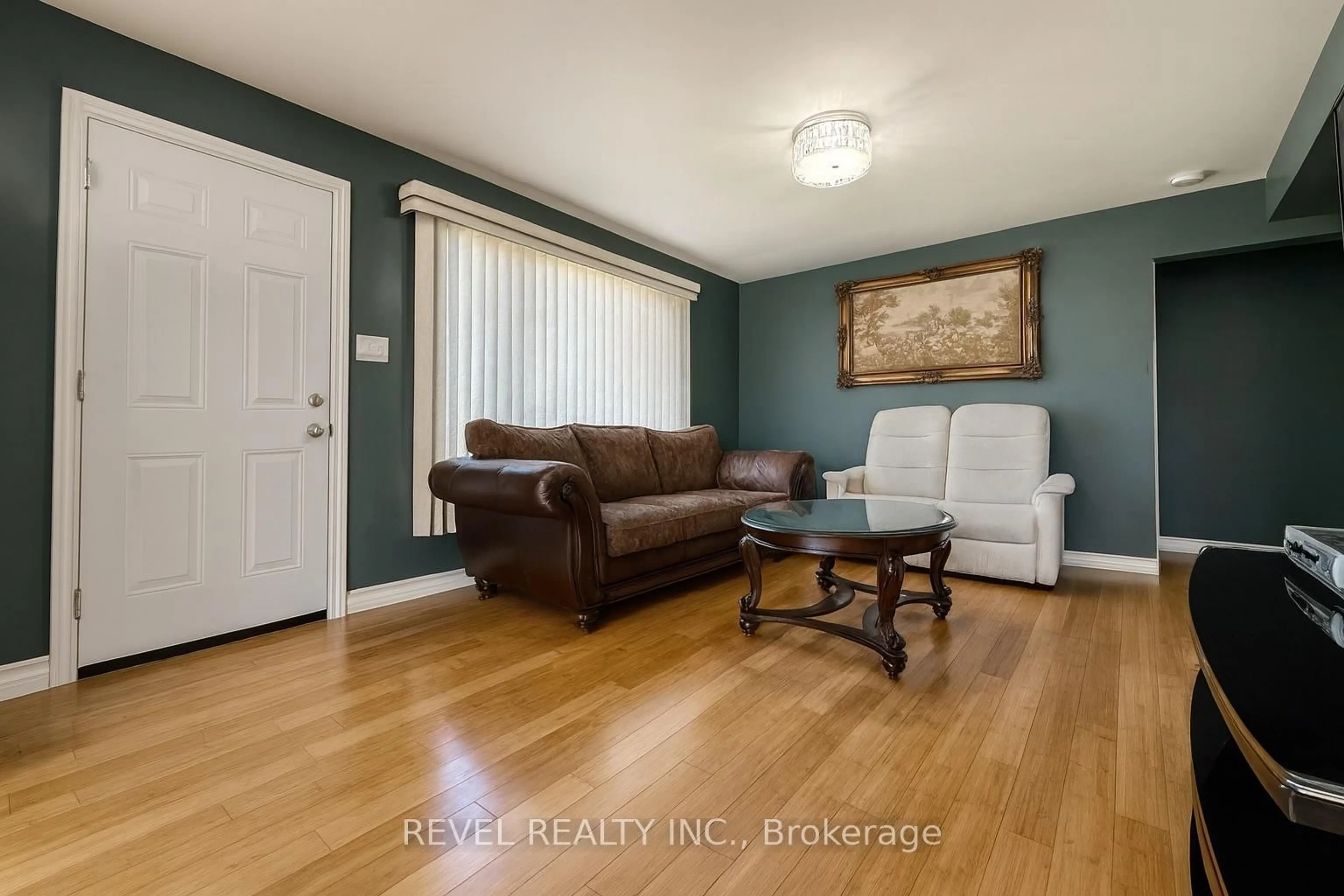 Living room with furniture, wood/laminate floor for 646 College St, Timmins Ontario P4N 5J8