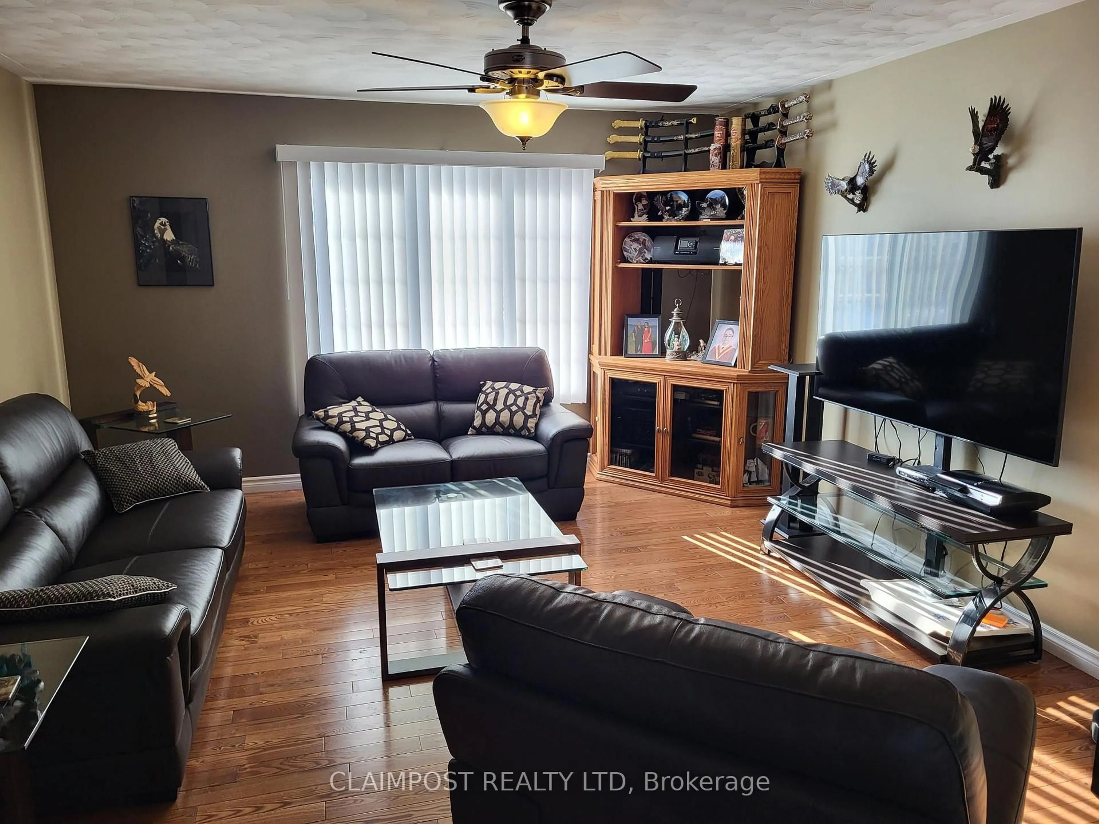 Living room with furniture, wood/laminate floor for 168 Moneta Ave, Timmins Ontario P4N 8L6