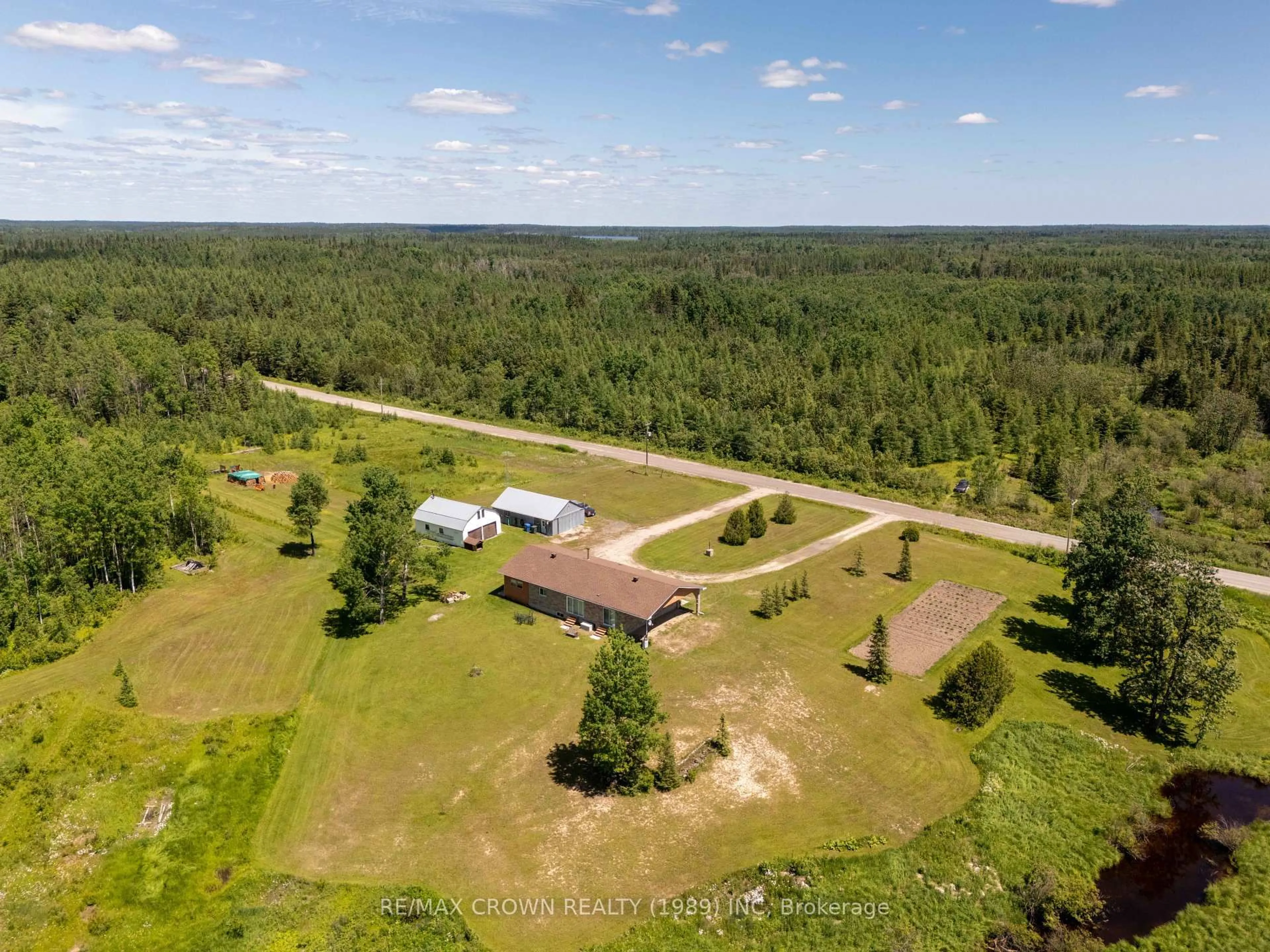 A pic from outside/outdoor area/front of a property/back of a property/a pic from drone, forest/trees view for 3 Nursery Rd #Moonbeam, Kapuskasing Ontario P0L 1V0