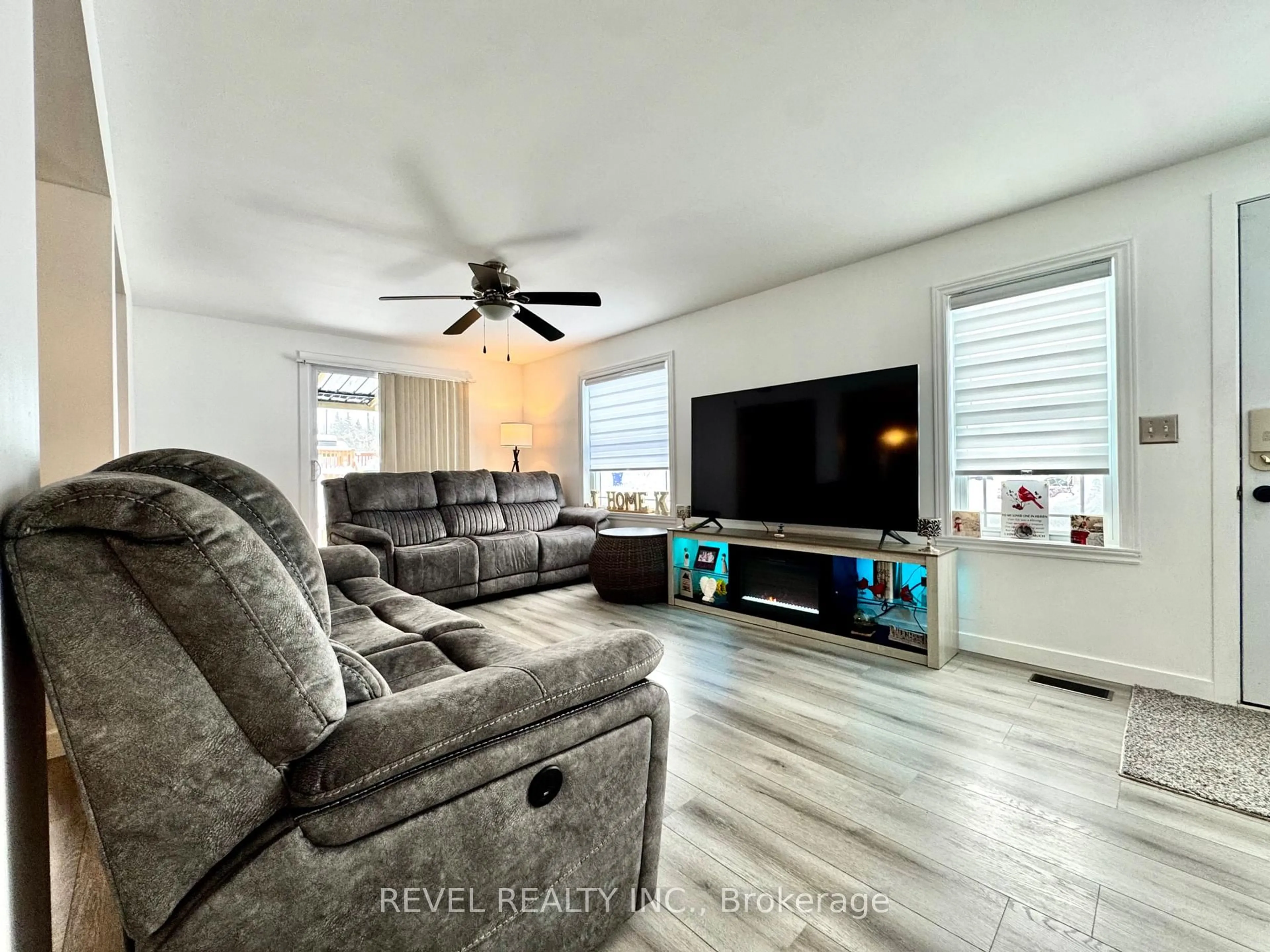 Living room with furniture, wood/laminate floor for 16 Foothills Lane, Timmins Ontario P4N 8R9