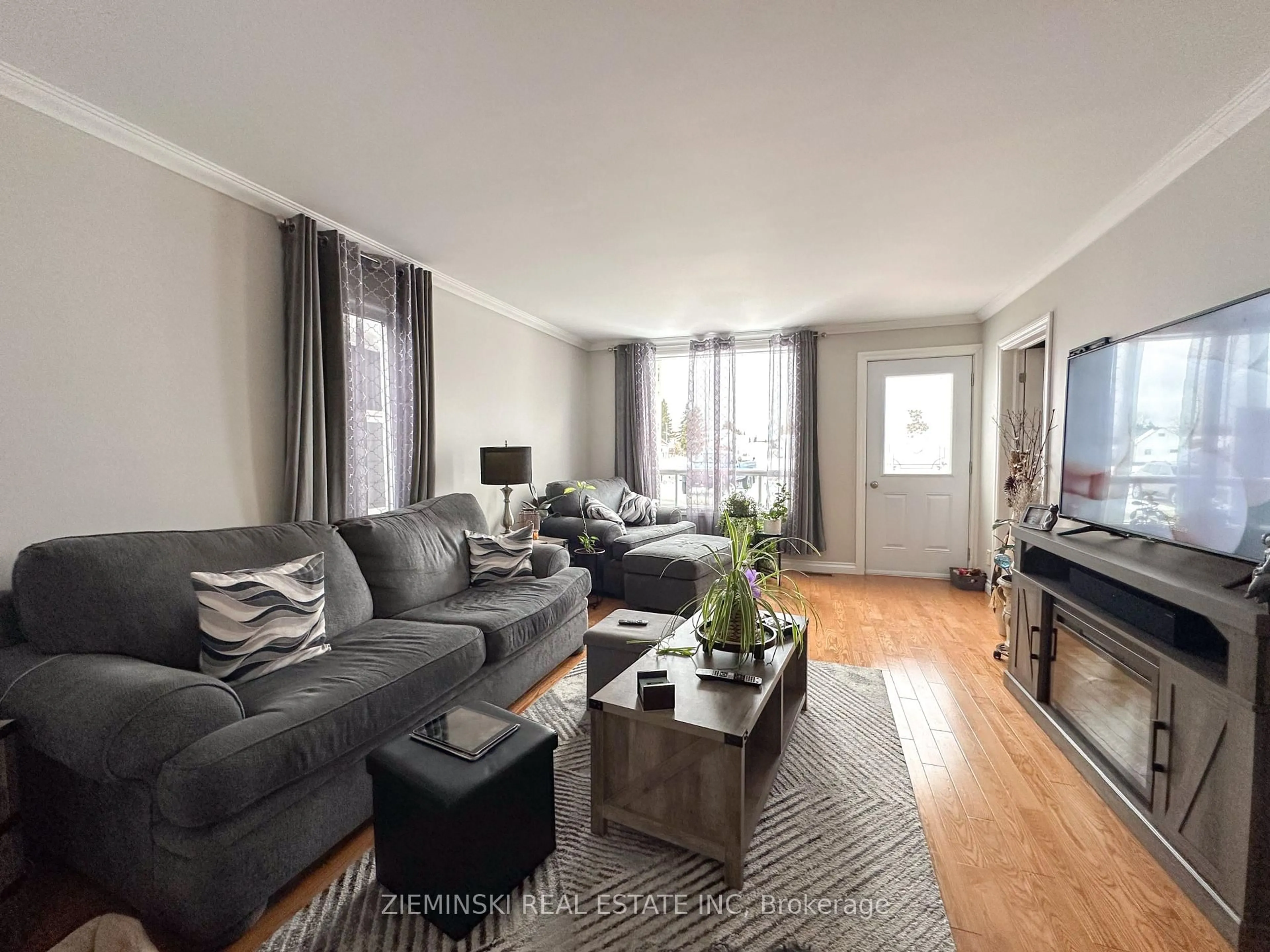 Living room with furniture, wood/laminate floor for 307 Ambridge Dr, Iroquois Falls Ontario P0K 1G0