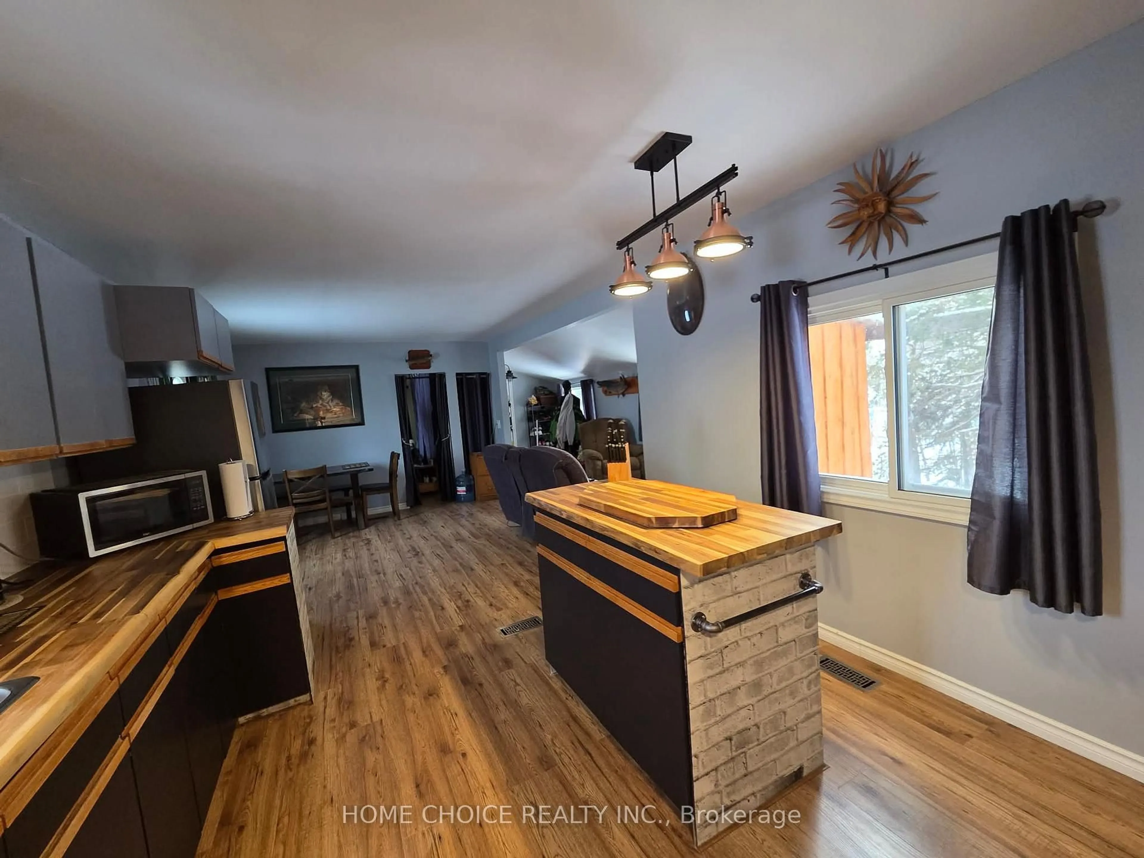 Open concept kitchen, wood/laminate floor for 150 Burnside Dr #15, Kirkland Lake Ontario P2N 3N9