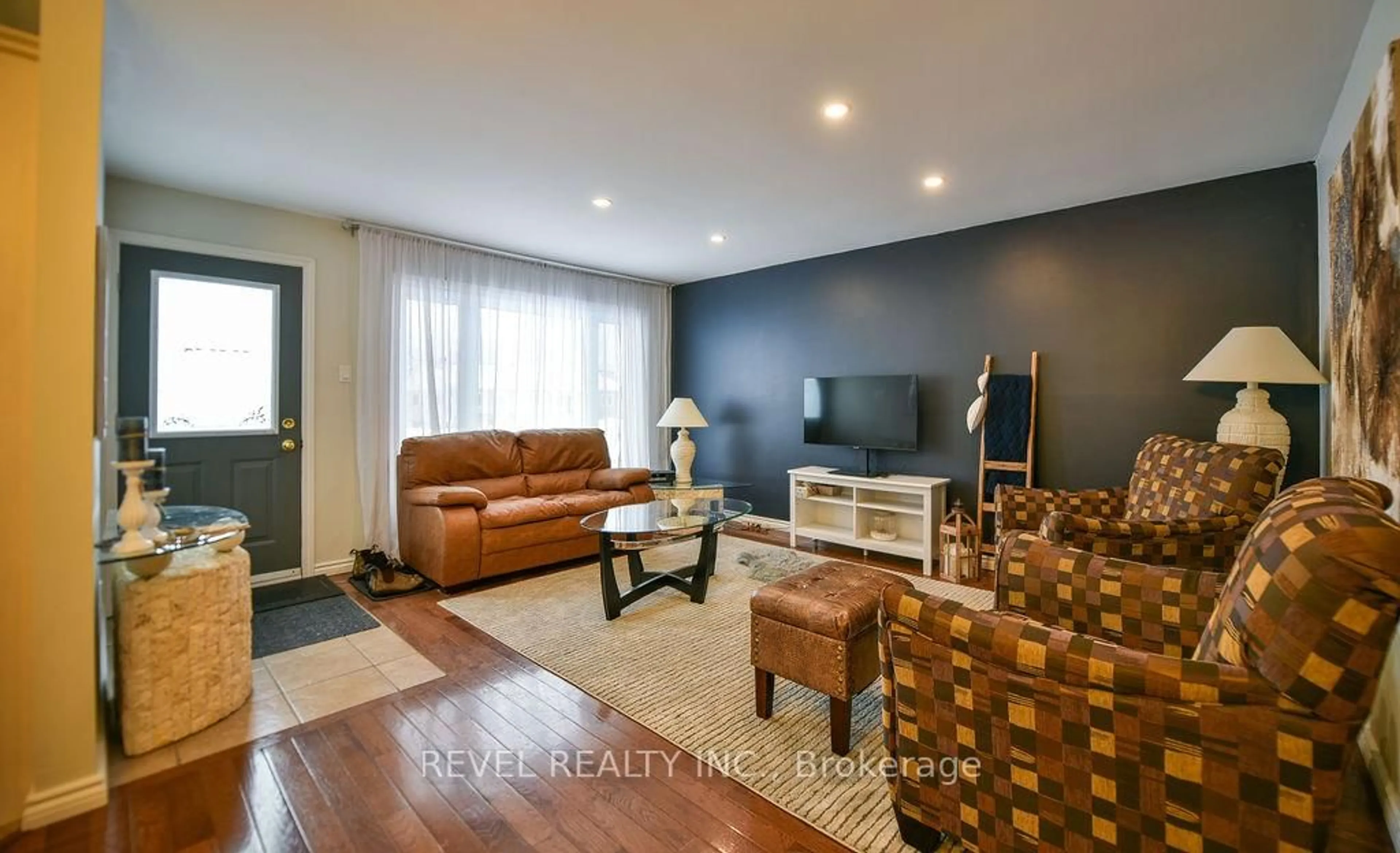 Living room with furniture, wood/laminate floor for 120 Delia Ave, Timmins Ontario P4P 1A1