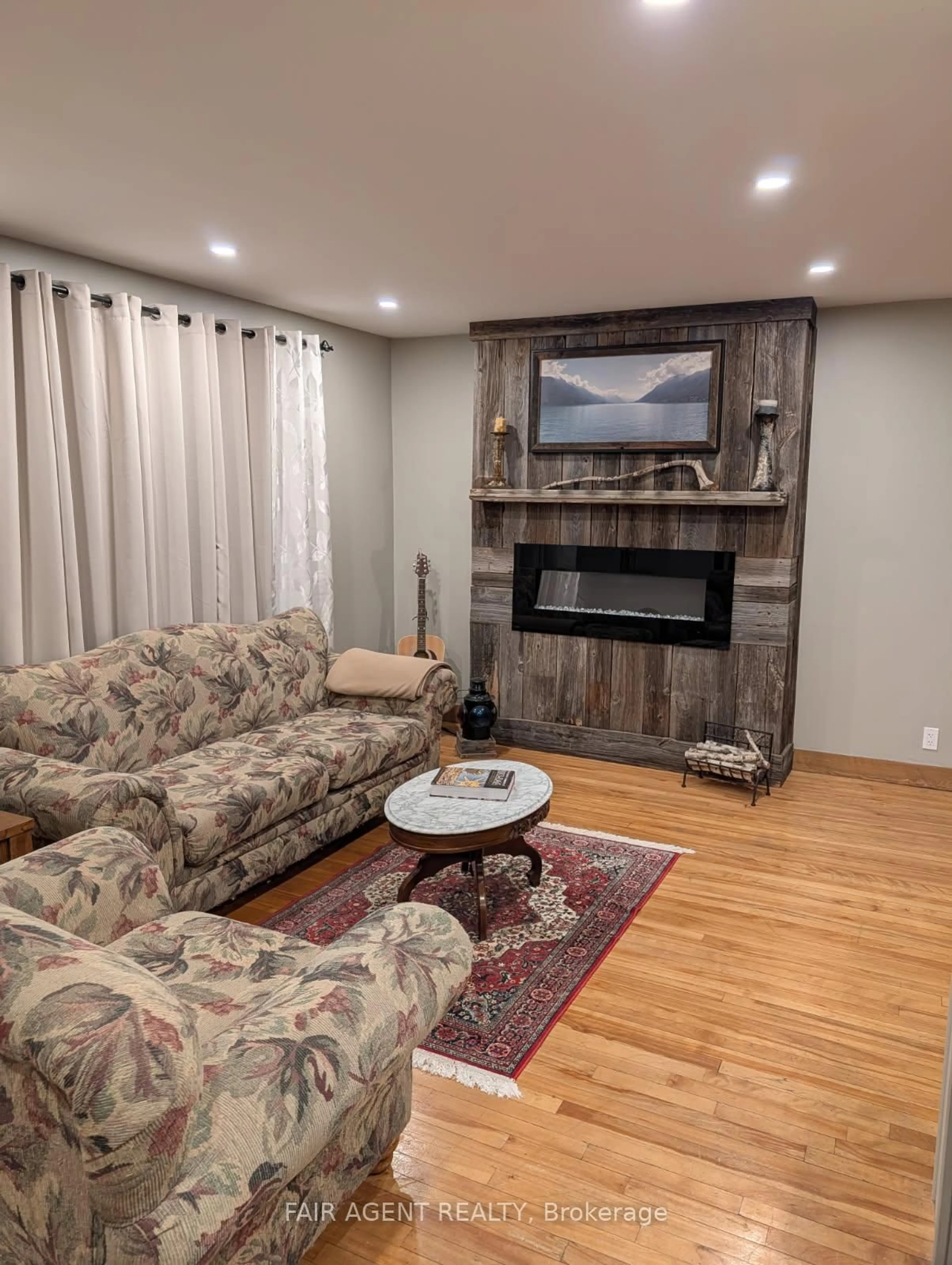 Living room with furniture, wood/laminate floor for 743022 & 743024 Dawson Point Rd, Timiskaming Ontario P0J 1P0