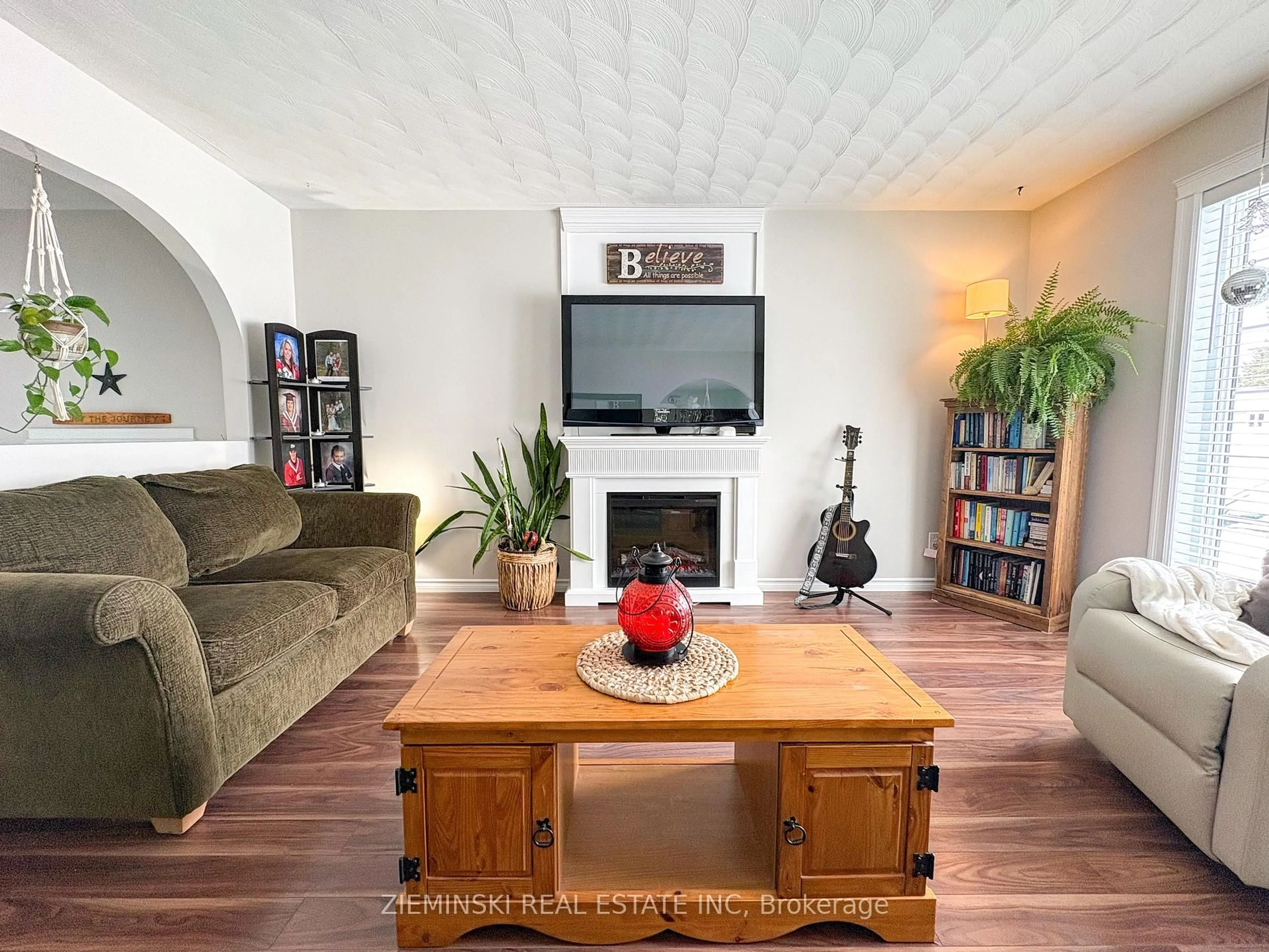 Living room with furniture, wood/laminate floor for 39 Sybil Ave, Cochrane Ontario P0L 1C0