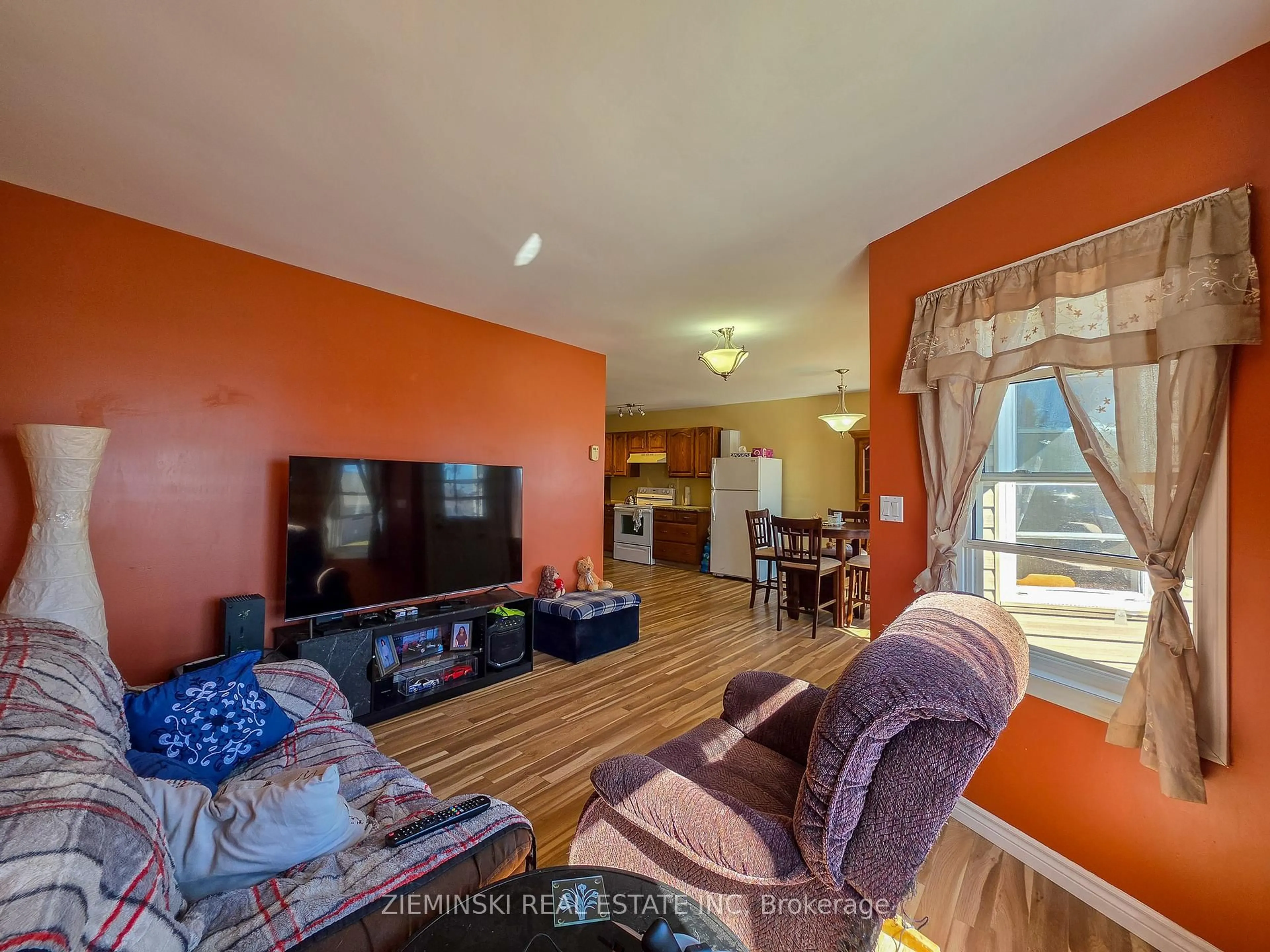 Living room with furniture, wood/laminate floor for 657 Cedar Ave, Iroquois Falls Ontario P0K 1G0